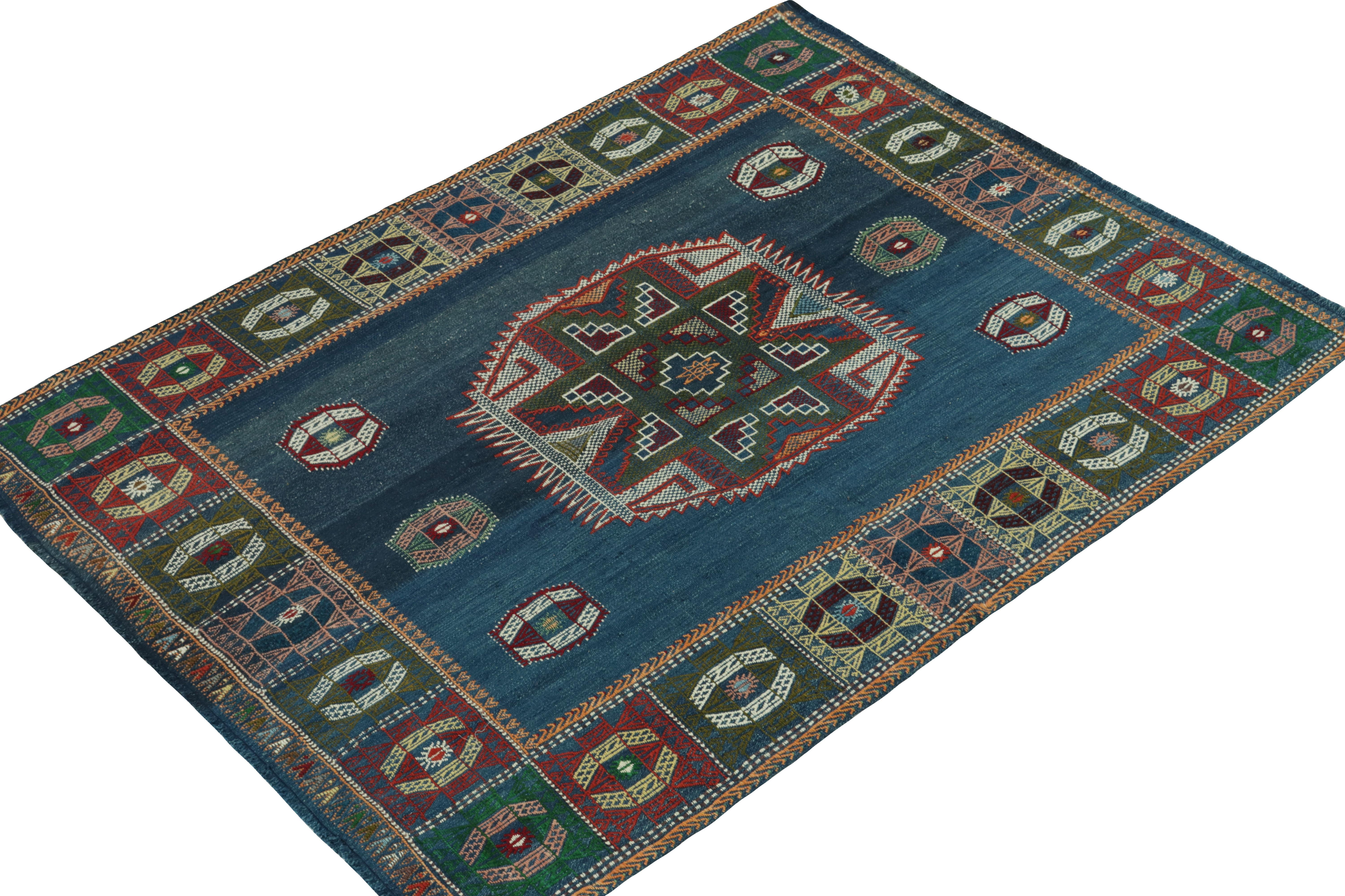 This vintage 5x6 tribal Kilim originates from Turkey circa 1950-1960. 

Handwoven in wool, its design favors medallion patterns in an open field and border with finely detailed squares. Keen eyes will note an embroidered texture in the patterns,