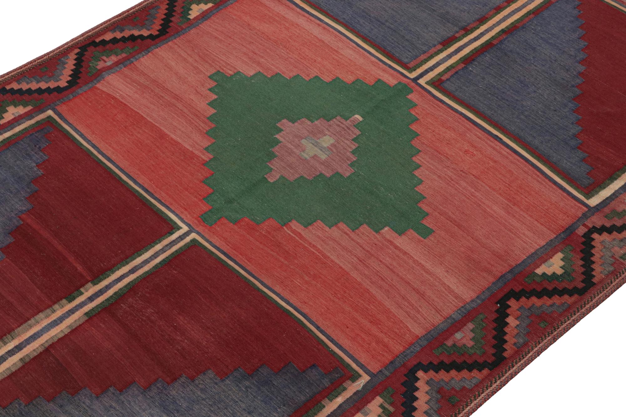 Handwoven in wool, this vintage 5x10 Turkish tribal Kilim of the 1950s is the grand new entry to Rug & Kilim”s repertoire of midcentury flatweaves. 

On the Design: 

The vintage flatweave boasts sharp geometric patterns in red, green & blue