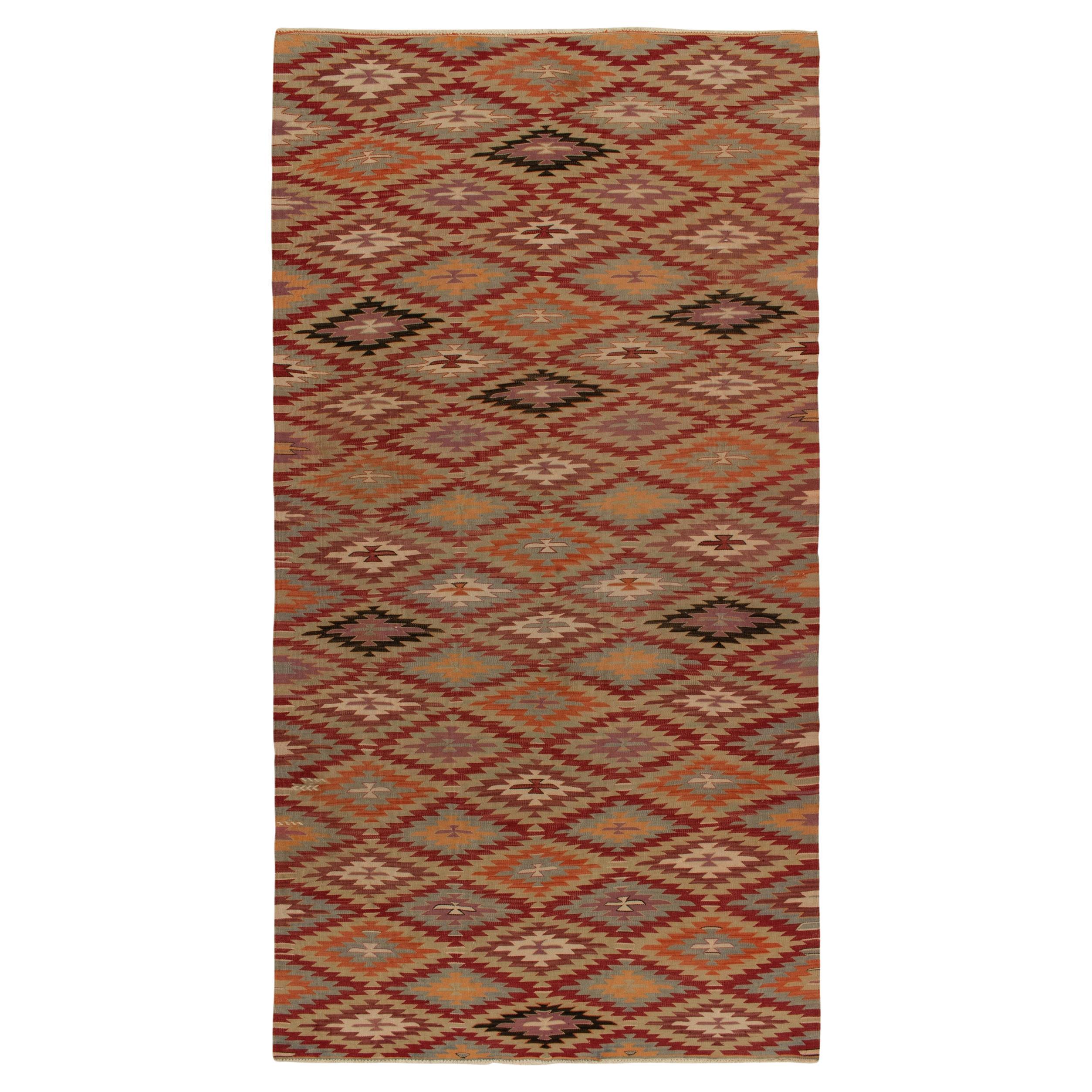Tapis Kilim tribal vintage à motifs géométriques rouges, oranges et bleus