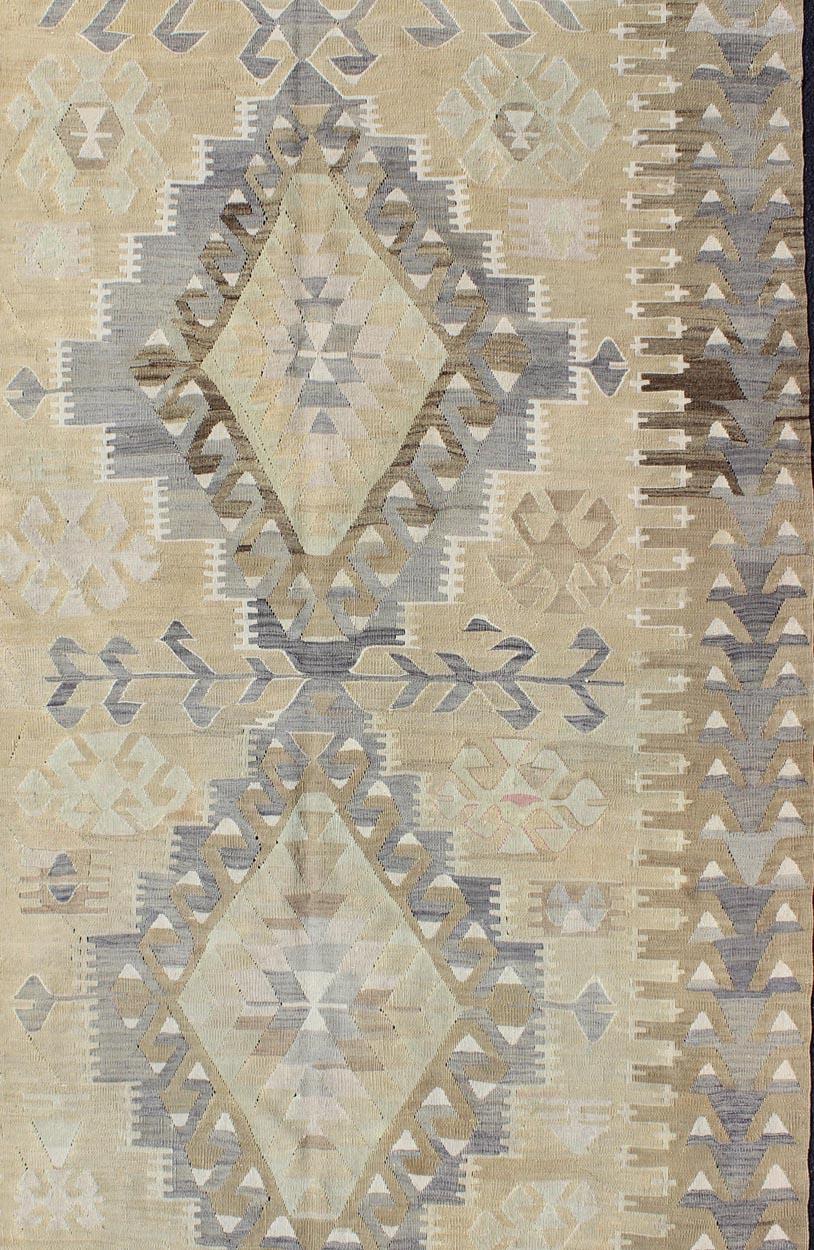 Tribal vintage Kilim with geometric design in warm tone background and border, taupe, gray and tan rug EN-305, country of origin / type: Turkey / Kilim, circa 1950, vintage Kilim, vintage Turkish Kilim

This unique and stunning Turkish Kilim dates