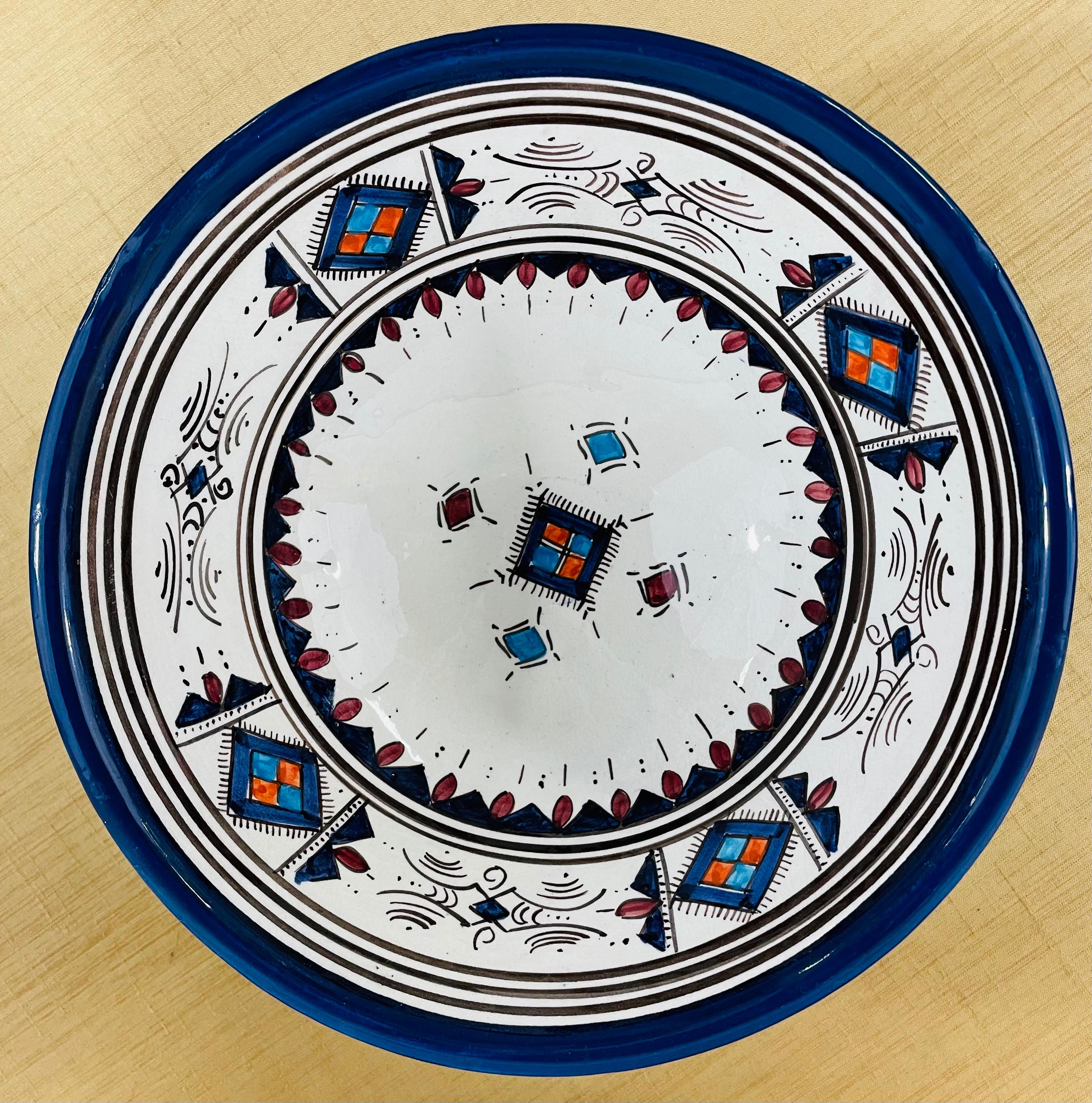 An exotic set of three handmade Moroccan tribal bowls in blue and white. Each piece features berber tribal motifs and elegant design. The set of bowls are perfect to decorate your dining or kitchen space, serve your favorite dish, soup ( the bowls