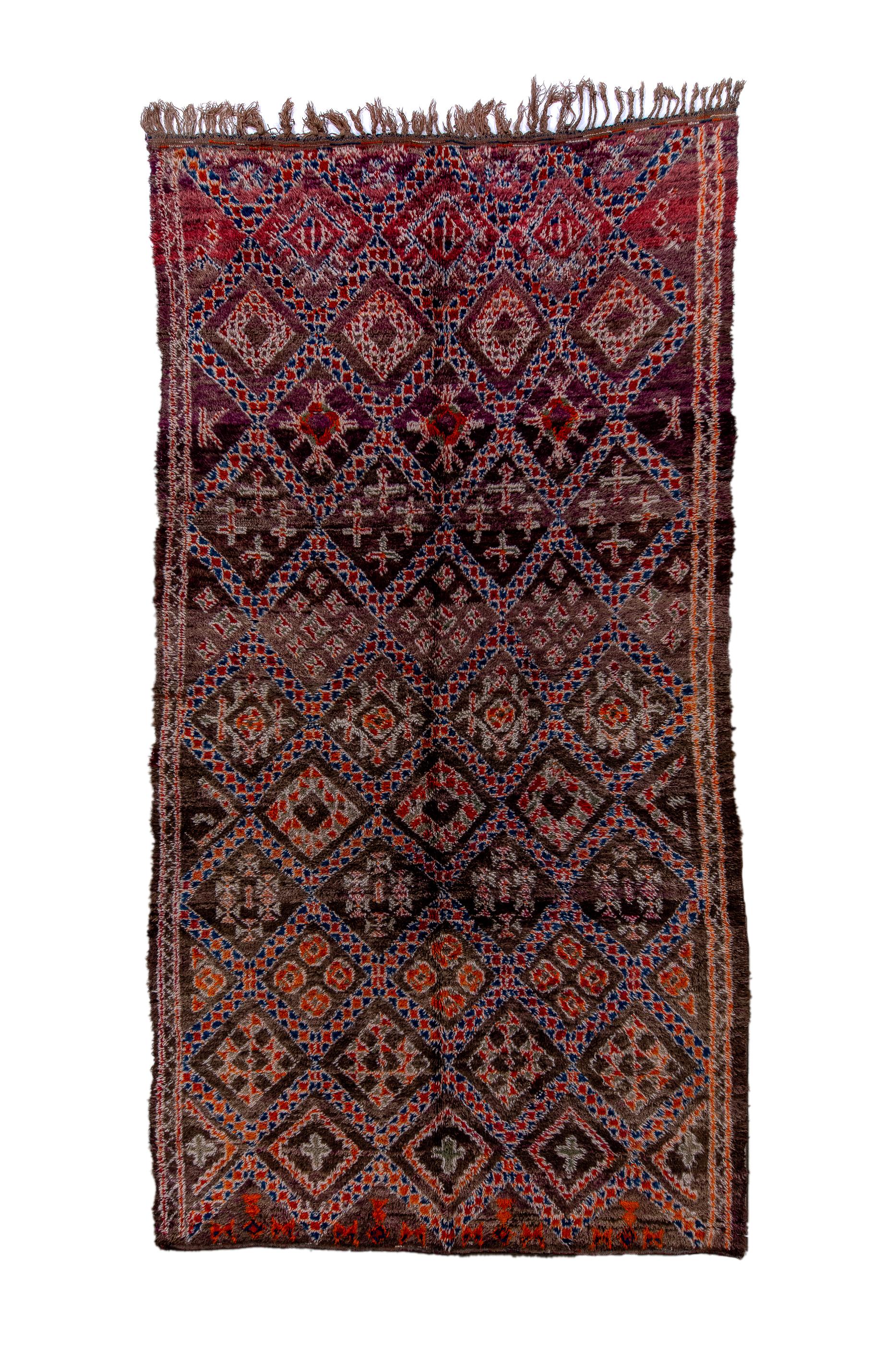 Coarsely woven on wool, this long pile tribal rug shows  a textured and thick lozenge lattice whose reserves enclose lozenges, ragged medallions, abstract floral crosses, and groups of small diamonds or octagons.  Row by row repetition across the