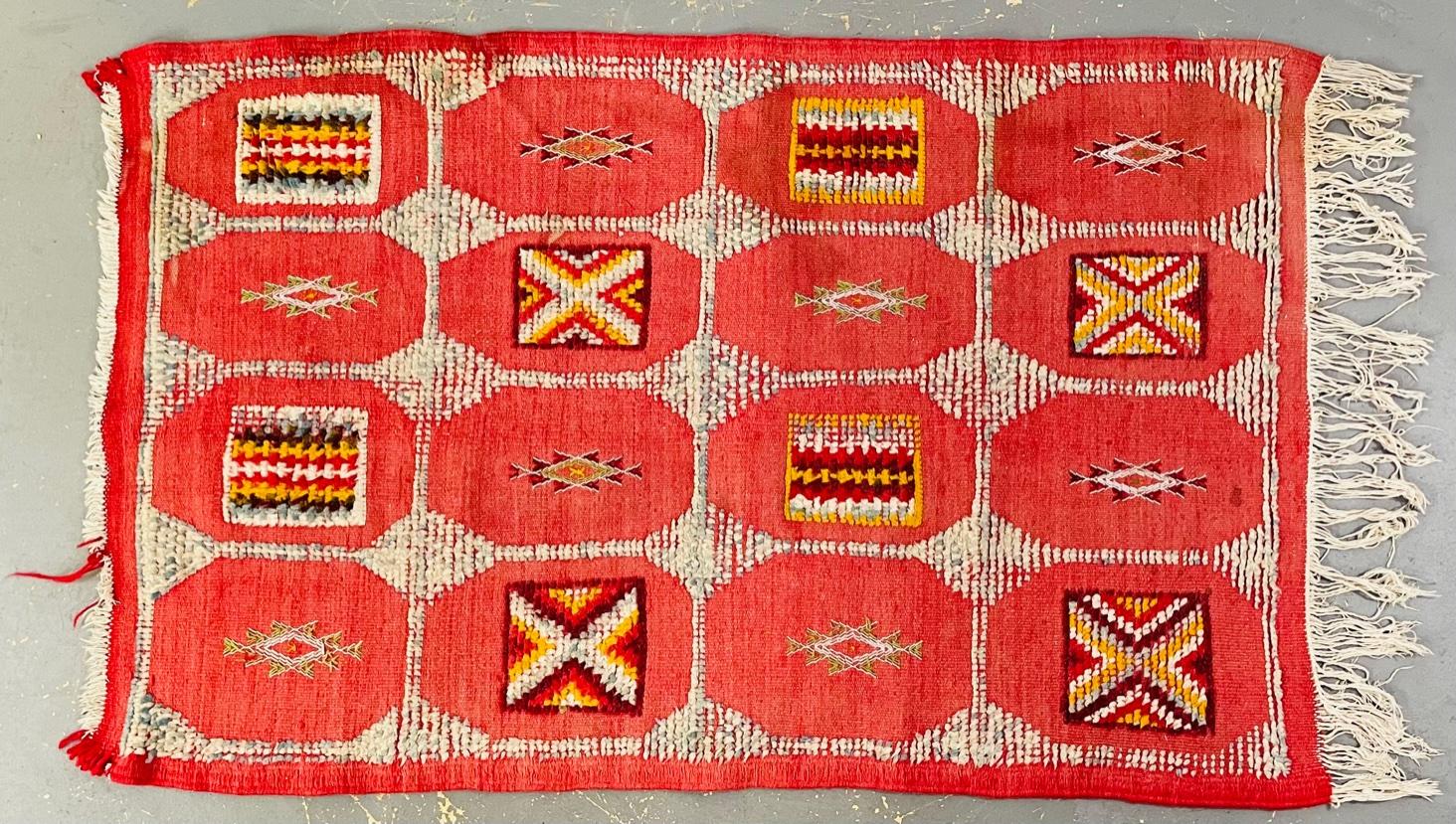 A vintage tribal Berber Moroccan hand-woven area rug or carpet in a flatware style. The rug features panels containing Berber tribal symbols and it is handmade using sheep wool and organic natural dyes. 
The rug aged gracefully as the red /pink