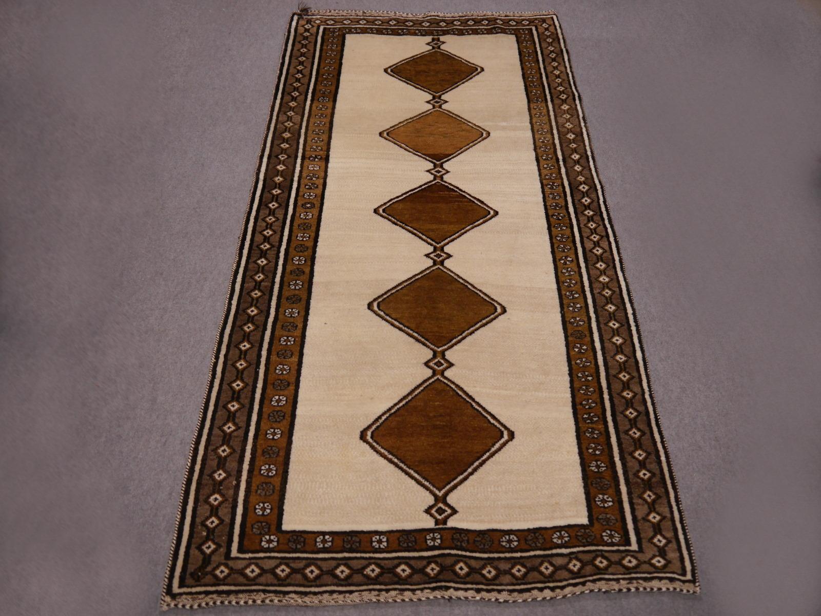 Mid-century style tribal rug with modern looking geometrical design. Goes well with many styles such as rustic Farmhouse, Hollywood Regency and Southwestern. All hand knotted with soft highland wool. Exquisite condition, full pile.