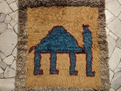 Vintage Tribal Rug with Headless Blue Camel on Desert Landscape