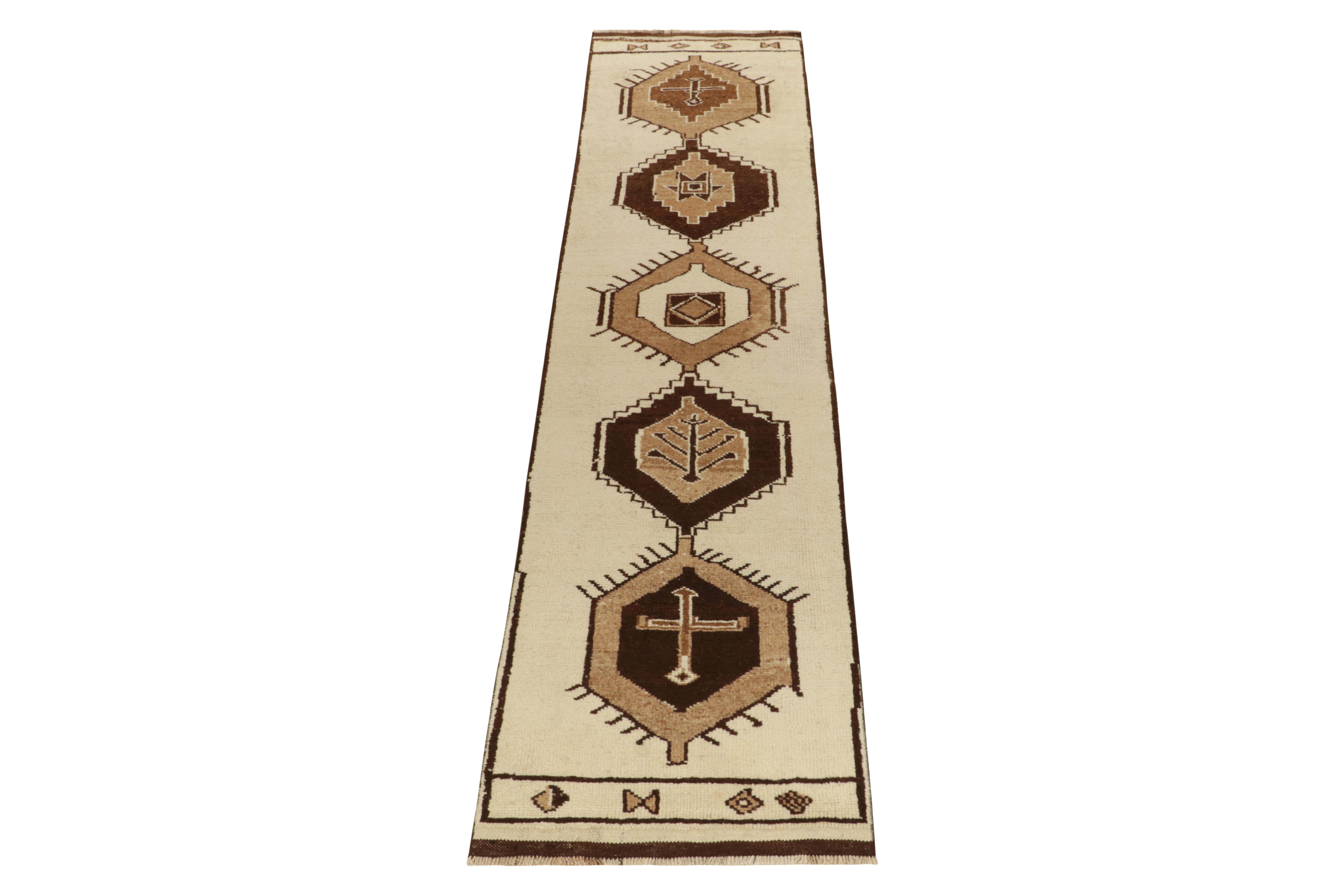 From Rug & Kilim’s vintage selections, a 3x12 hand-knotted wool runner from Turkey bearing striking nomadic influences. 

The 1950s tribal piece showcases traditional motifs on the field in creamy white & beige brown tones casting a gorgeous