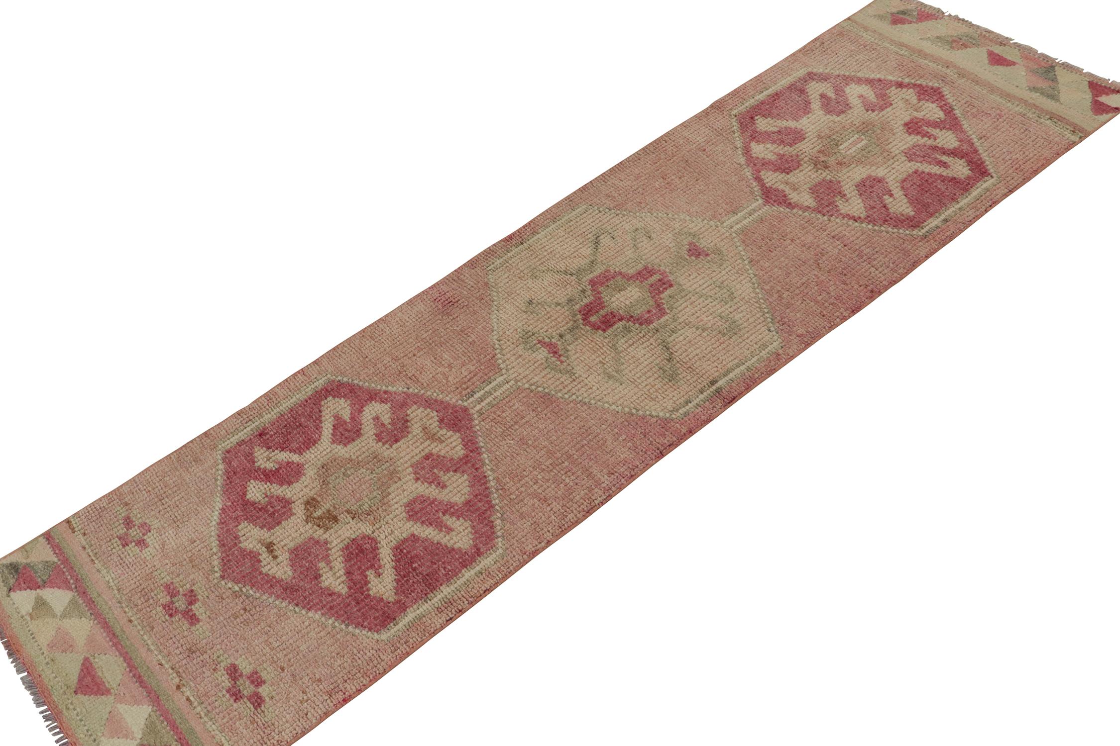 Originating from Turkey circa 1950-1960, a vintage tribal runner from a special curation of pieces newly acquired by R&K Principal Josh Nazmiyal. Hand-knotted in wool, the piece carries tribal medallions with an unusual emphasis on onion pink and