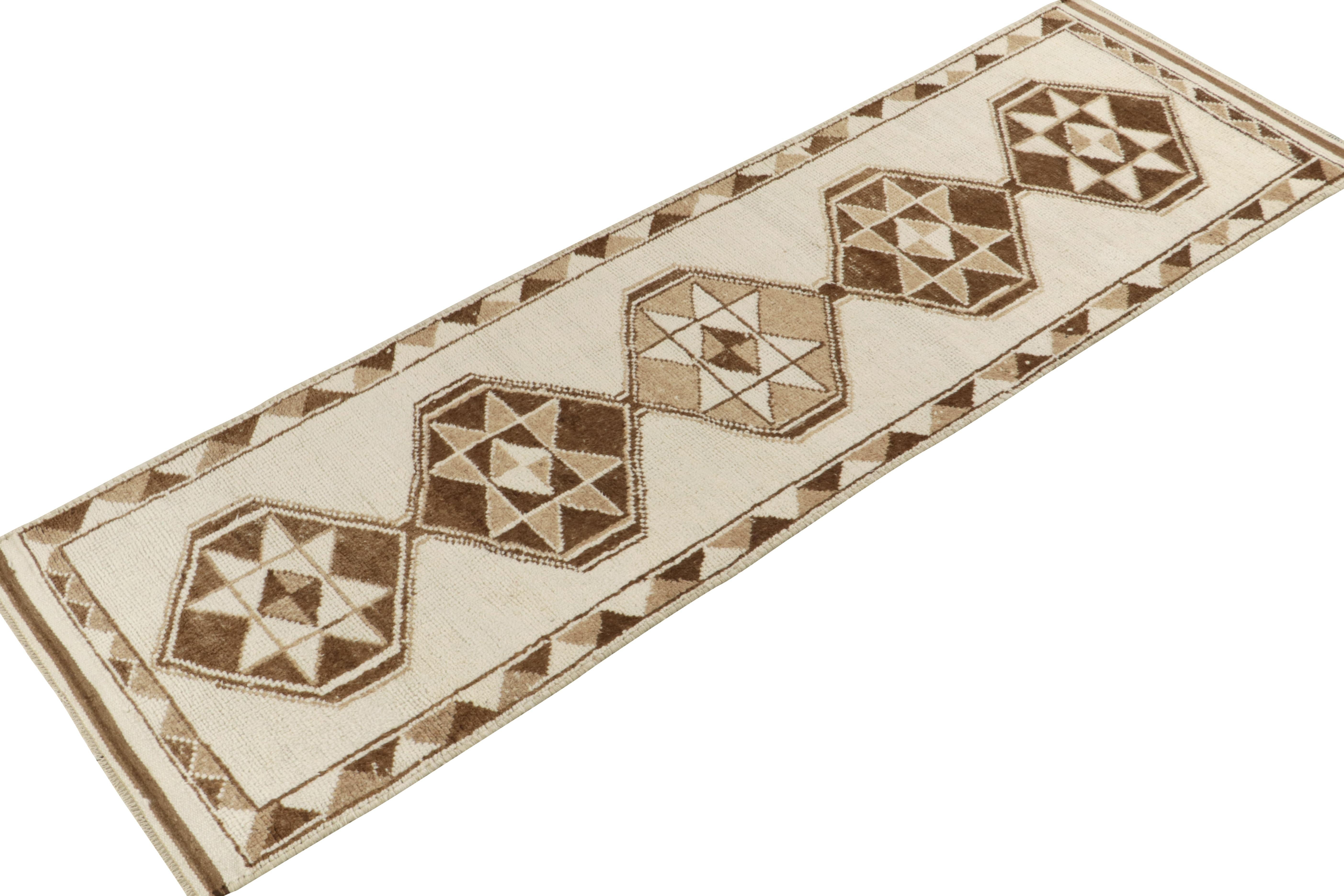 From Rug & Kilim’s vintage selections, a 3x11 hand-knotted wool runner from Turkey bearing striking nomadic influences. 

The 1950s tribal piece showcases traditional motifs on the field in bright white & beige brown tones casting a gorgeous