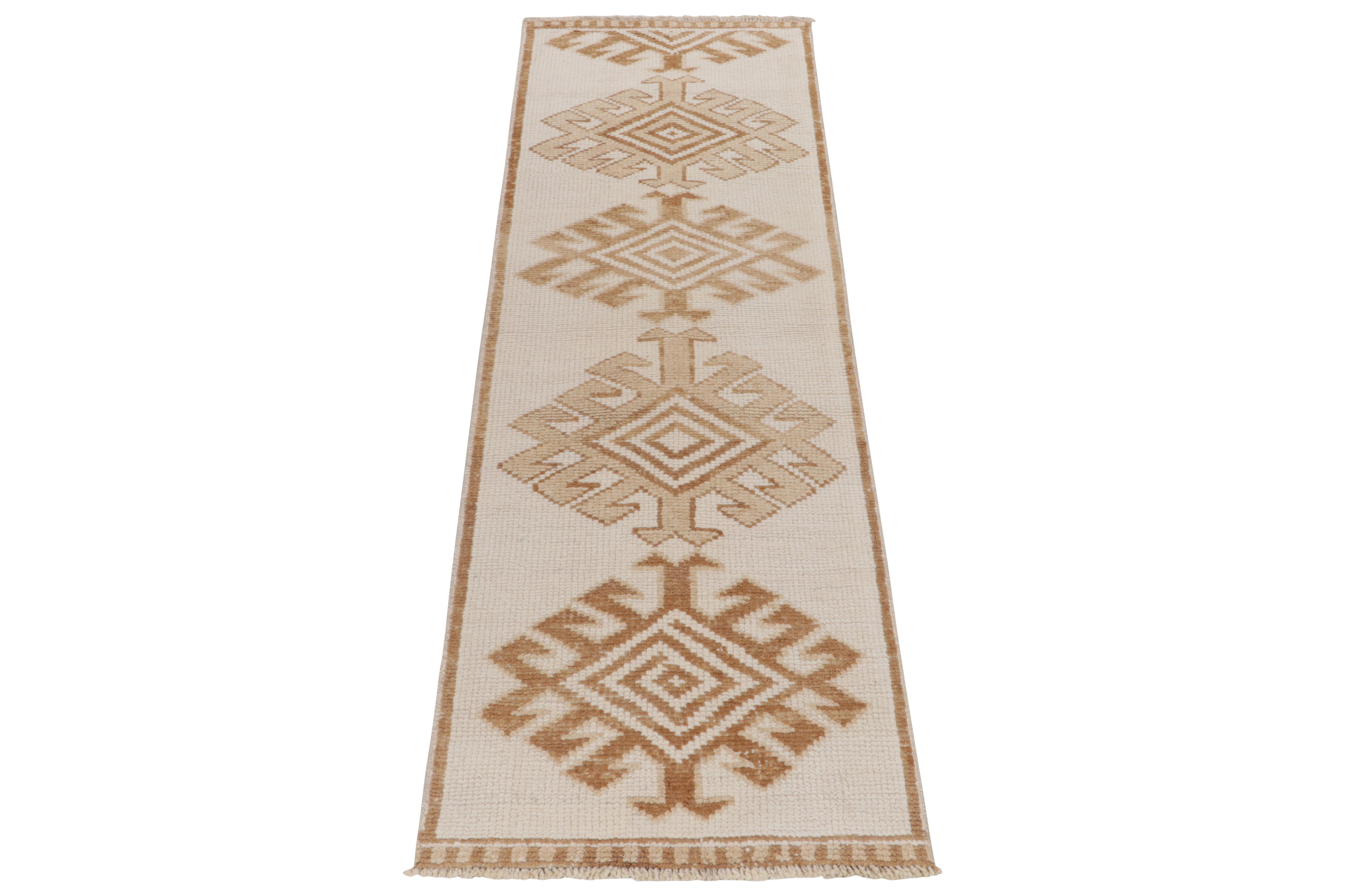 From Rug & Kilim’s vintage selections, a 3x10 hand-knotted wool runner bearing striking nomadic influences. The 1950s tribal piece showcases traditional motifs with latch hooks on the field in creamy white & brown tones casting a gorgeous gradient