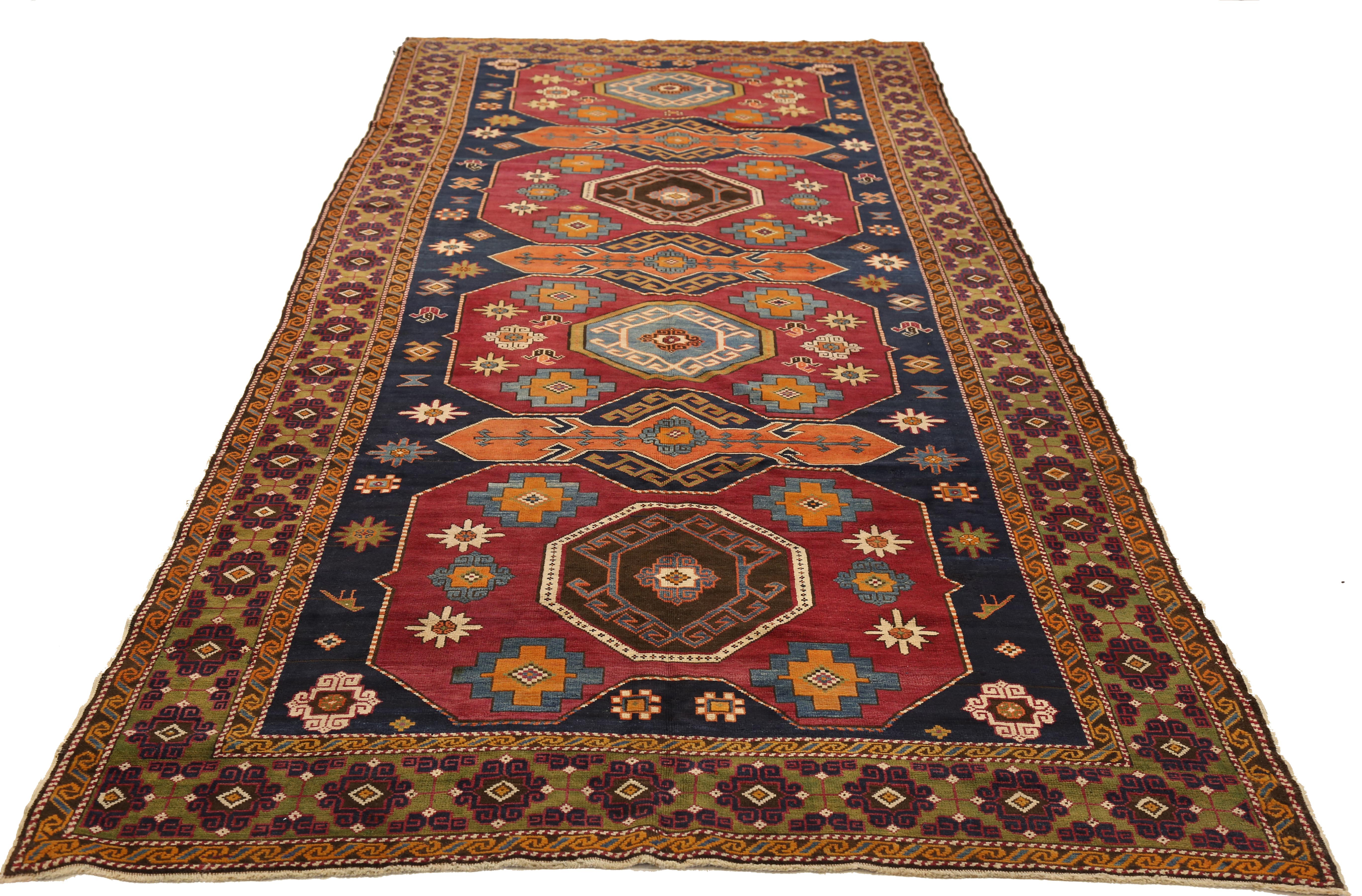 Vintage tribal Russian rug handwoven from fine wool and all-natural vegetable dyes that are safe for people and pets. It features a unique mix of geometric and botanical patterns that distinguish Caucasian rugs from other carpets. The dark