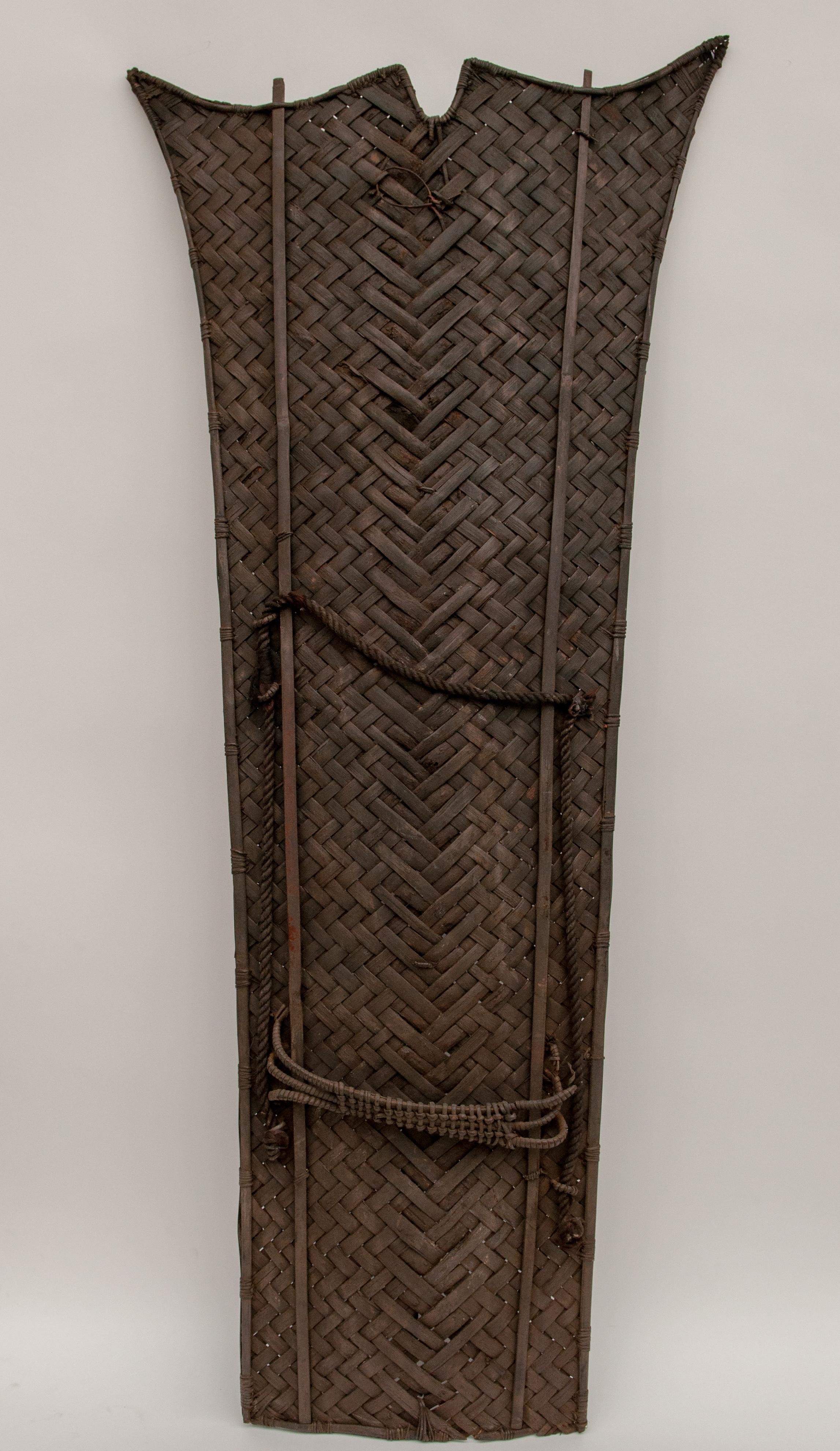 Vintage Tribal Shield of Cane & Bamboo. From Nagaland, Northeast India. Mid-20th Century.
Offered by Bruce Hughes.
This shield was most likely for ceremonial use, possibly in the playing out of mock battles between village clans. The rising corners