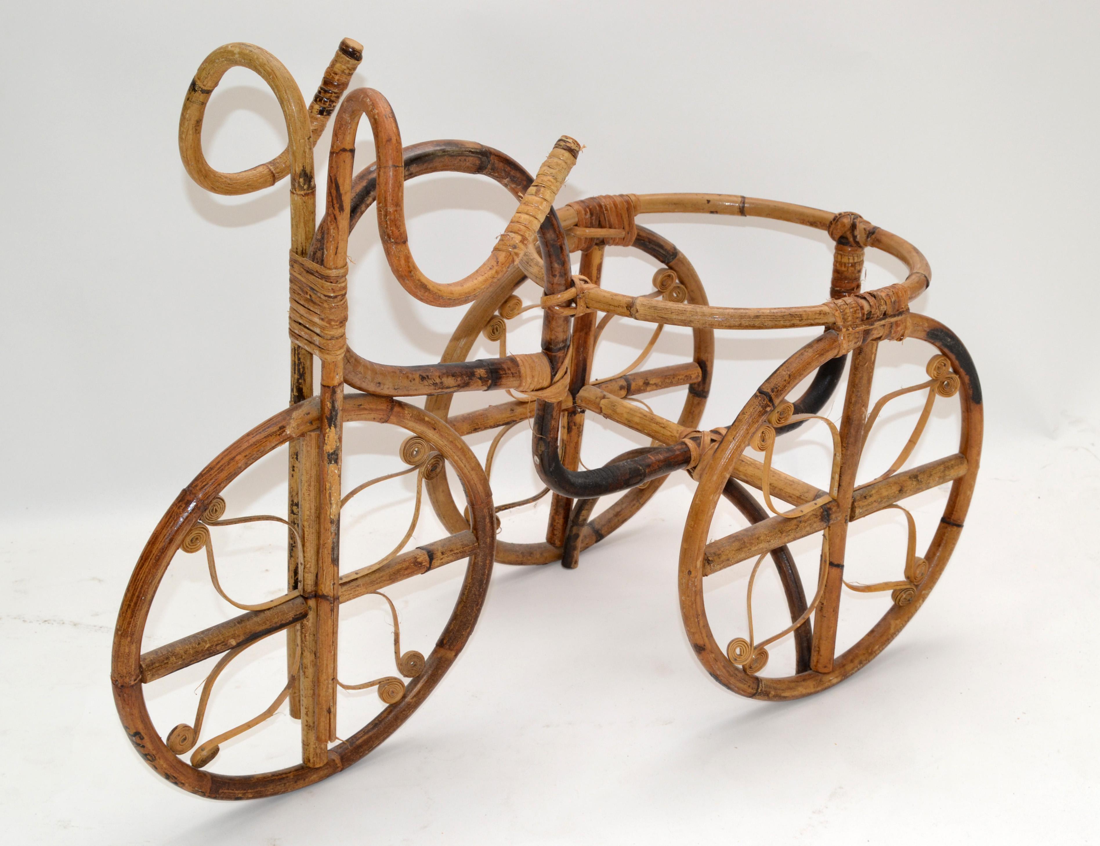 Early 1970s vintage handcrafted Tricycle made out of bamboo & cane for plants or other Décor.
Can be used indoor or outdoor in the Porch Area.

 