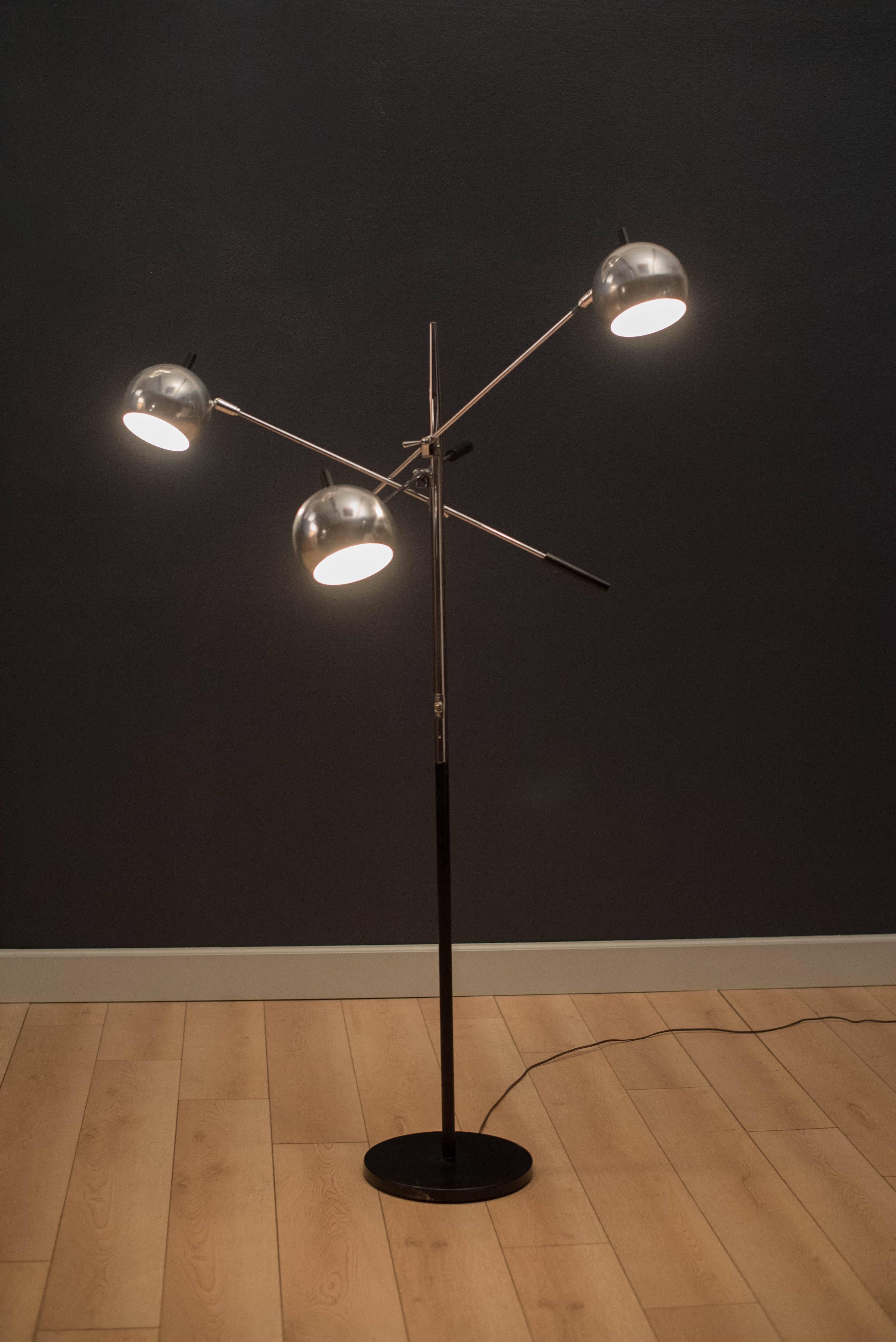 Mid-Century Modern Triennale floor lamp designed by Robert Sonneman. This versatile piece features three adjustable chrome globe lights that pivot on balancing lever arms.