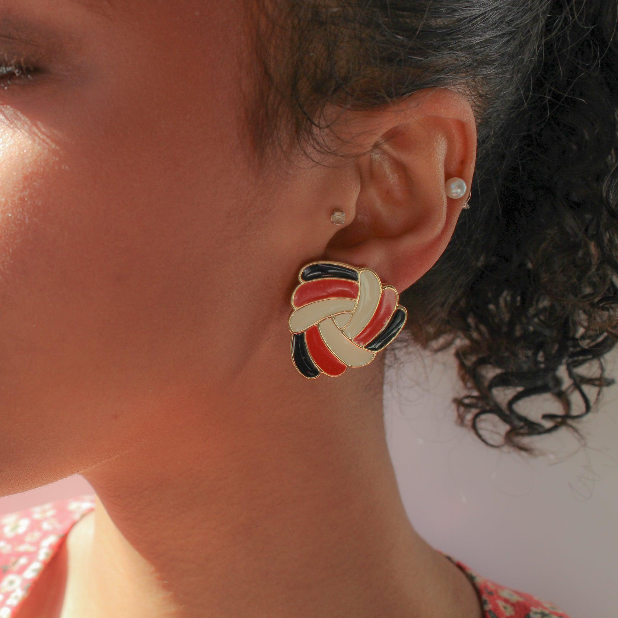 Trifari Vintage 1970s Earrings for Pierced Ears

Made in the USA in the early 1970s. Crafted from gold plated metal and a rich red, black and cream geometric design.

Since the 1920s, Trifari has been one of the most respected and admired producers