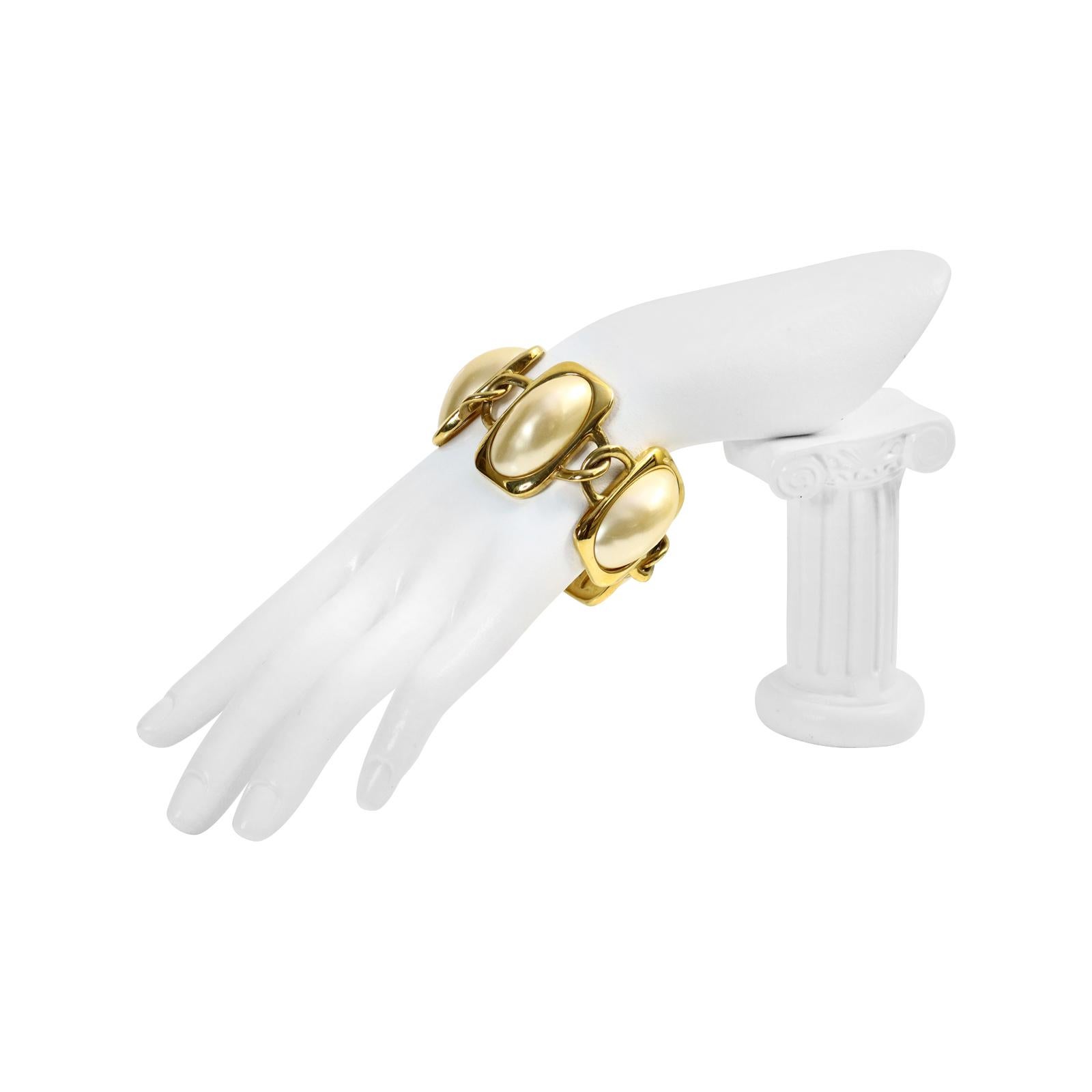 Vintage Trifari Gold Tone Large Faux Pearl Bracelet.  Such a Classic piece. Wear alone or mixed with others.  Always looks in style.  A Classic Pearl and gold bracelet alone or stacked up on your arm can make track pants with a white blouse and