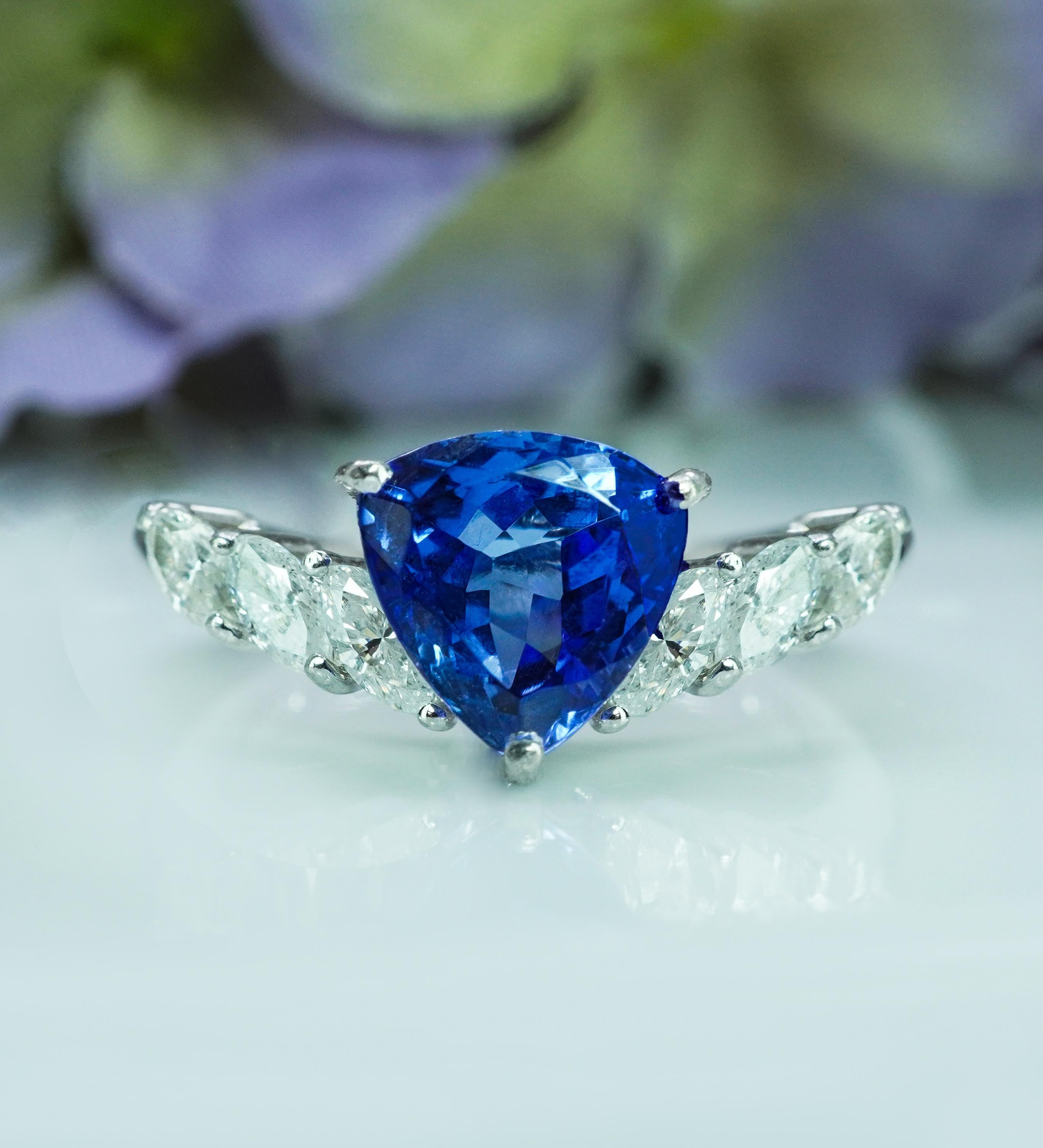   Vintage Trillion Gem Tanzanite Marquise Diamond Platinum Chevron Ring Estate 

This fascinating estate vintage piece is crafted in luxurious and expensive platinum. Featured in the center is a genuine earth mined trillion cut Tanzanite measuring