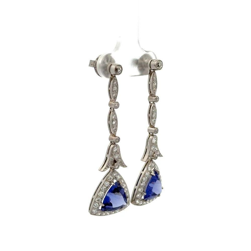 Simply Beautiful! Finely detailed Oscar Worthy Diamond and Trillion Tanzanite Platinum Statement Drop Earrings. Each earring Hand set with a Trillion Tanzanite Gemstone, weighing approx. 5.61tcw for both. Artfully surrounded by Old European cut