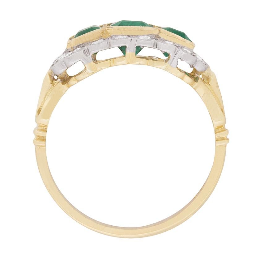 This unique ring dates to the 1950s and is etymologically vintage. It features a trio of emerald cut emeralds which are a fantastic deep green. They have a combined weight of 2.50 carat, the centre weighing 1.20 carat and the two adjacent 0.65