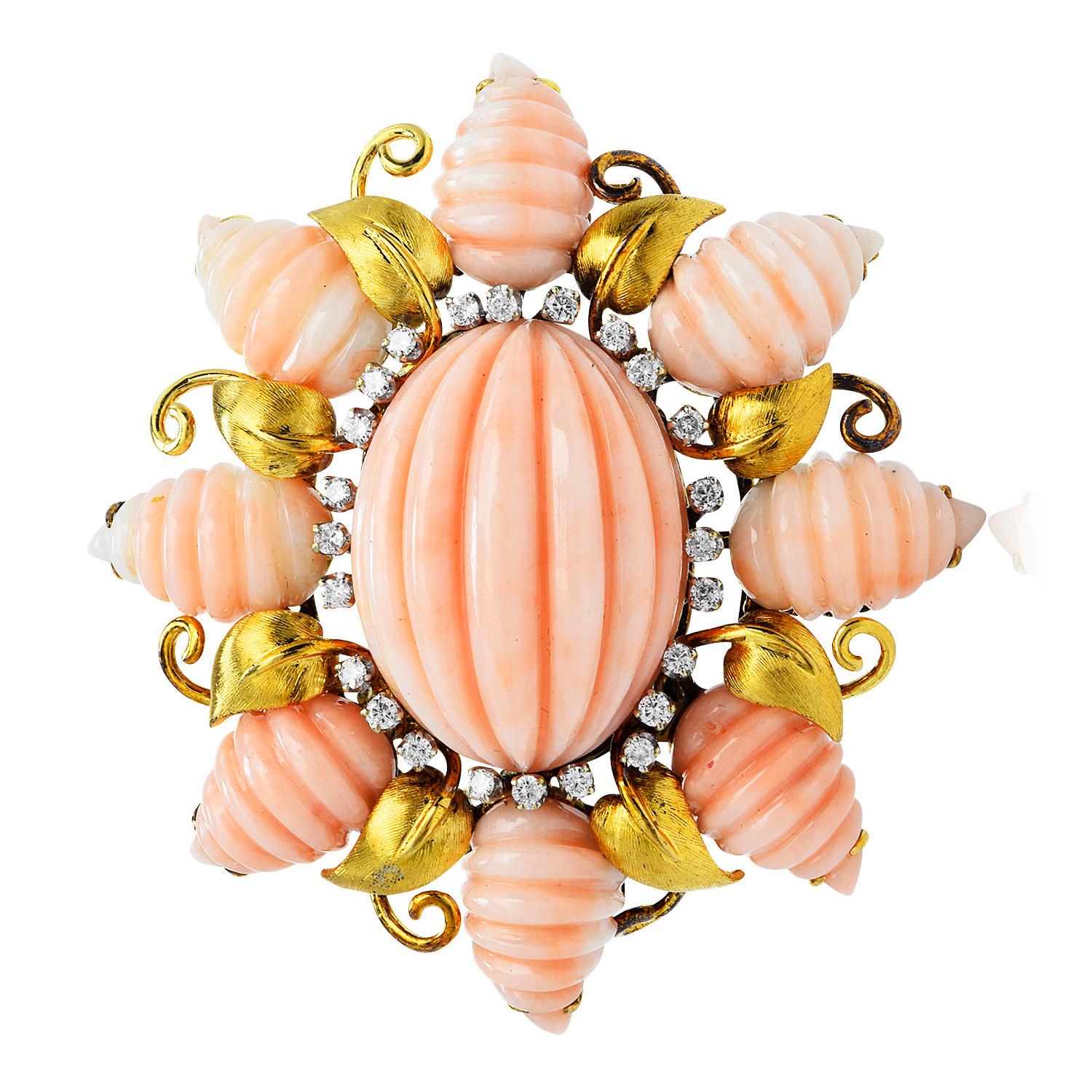 With an exquisite textured design by TRIO, these enchanting vintage pink Carved coral & diamond piece is crafted in solid 18K yellow gold.
Centered by a genuine cabochon oval channeled pink Coral, measuring 27 mm x 22 mm x 14 mm, and adorned with