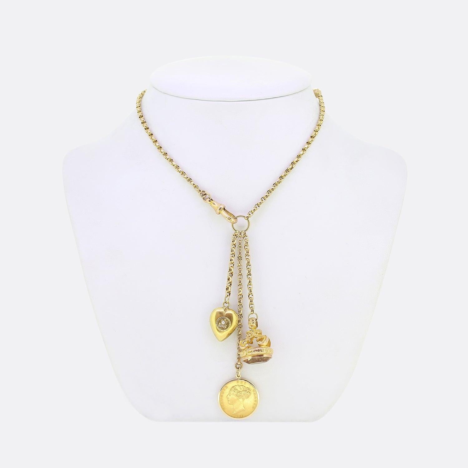 Here we have a vintage 9ct yellow gold faceted belcher chain charm necklace. The necklace plays host to a trio of pendants including an ornate citrine set fob, pearl and rose cut diamond set love heart and finally a 22ct sovereign coin featuring a