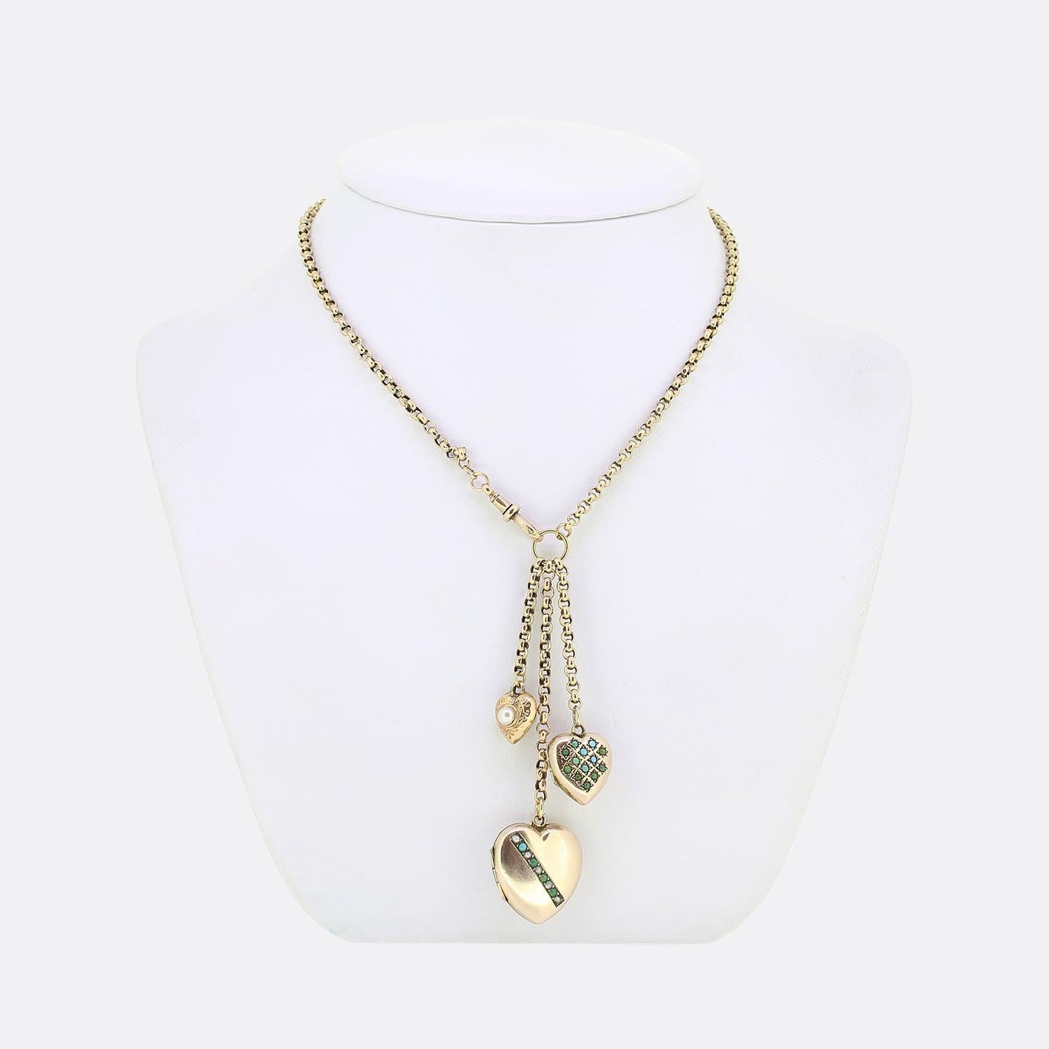 This is a vintage 9ct yellow gold belcher chain link charm necklace. The necklace plays host to a trio of love heart pendants which hang harmoniously side-by-side; two of which are lockets set with seed pearls and green and blue turquoise. The