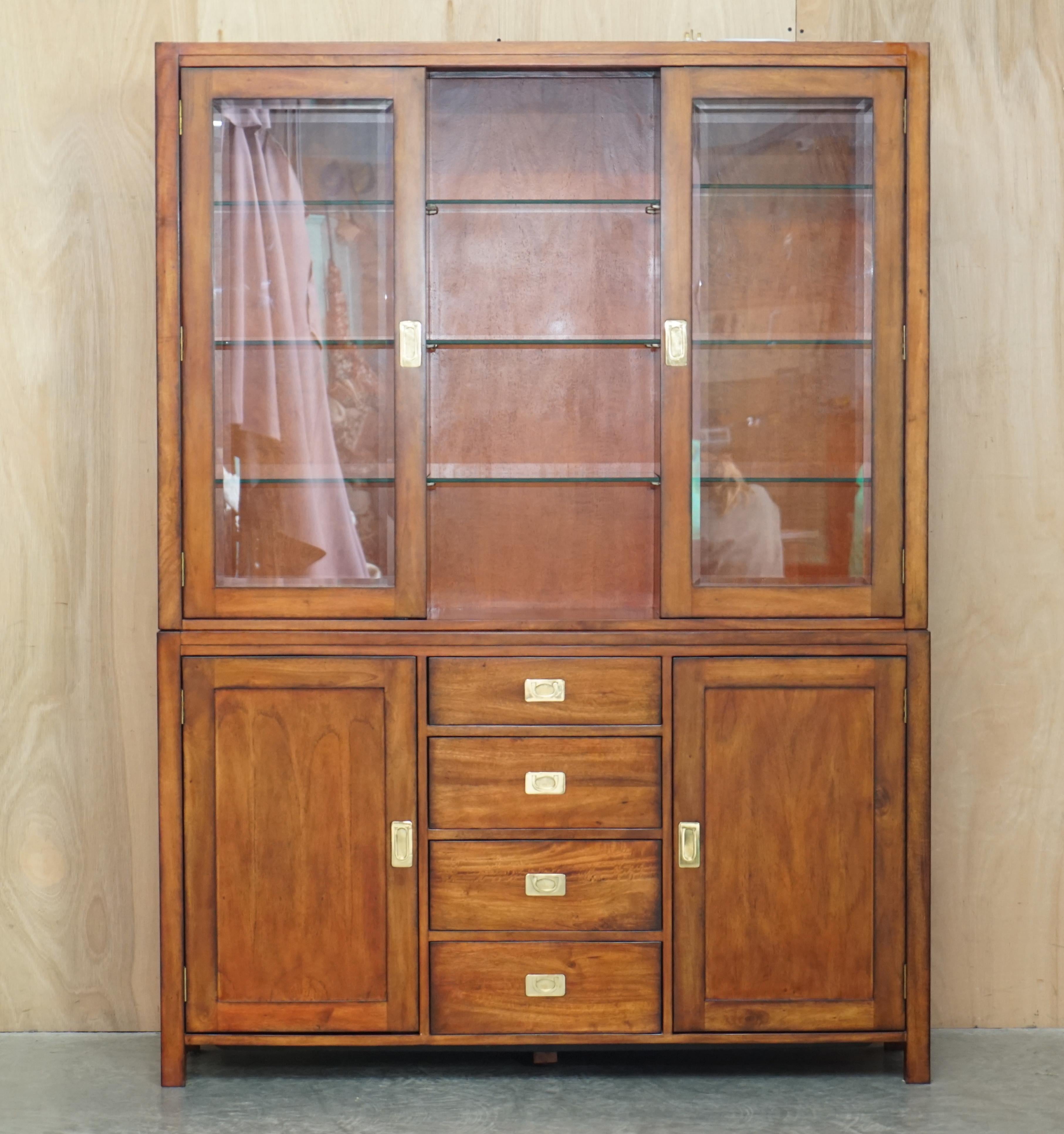 We are delighted to offer for sale this stunning Vintage Multiyork Military Campaign library bookcase with drawers and glass shelves finished with three spot lights 

Please note the delivery fee listed is just a guide, it covers within the M25