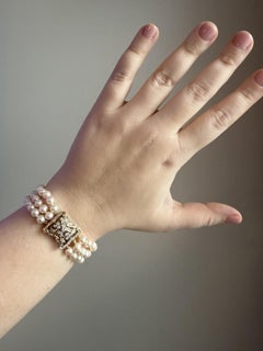 Bracciale vintage con tre fili di perle e chiusura con diamanti in oro giallo 14K