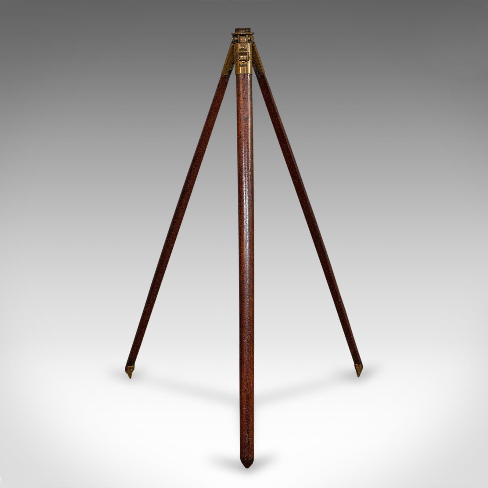 This is a vintage tripod. An English, mahogany and bronze helio, telescope or lamp stand with maker's mark, dating to the mid-20th century, circa 1941.

Displays a desirable aged patina
Mahogany shows fine grain interest
Bronze hardware