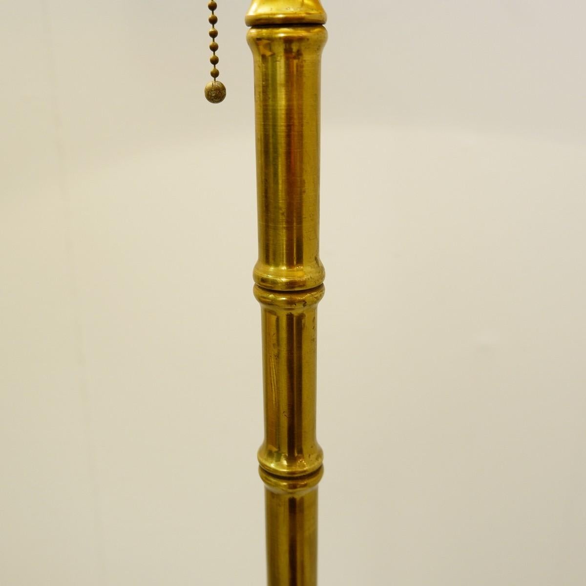 Vintage tripod faux bamboo brass floor lamp from Maison Baguès.