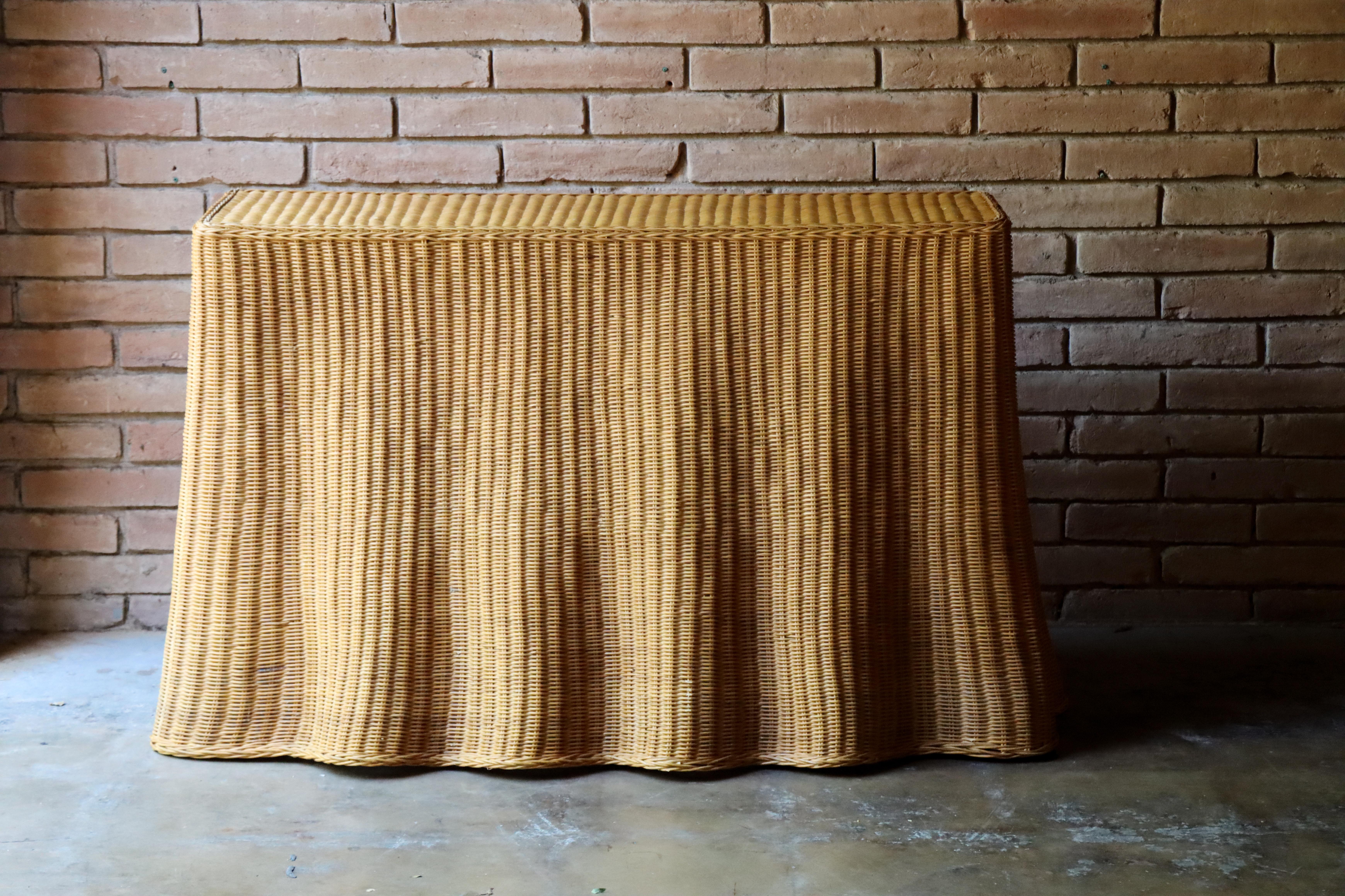Vintage Trompe L'oeil 'Draped' wicker ‘ghost’ console table. This beautiful console features a draped illusion fantastically crafted in wicker. Perfect scale.

Normal vintage wear with a few small nicks and minor breaks. Still shows very well with