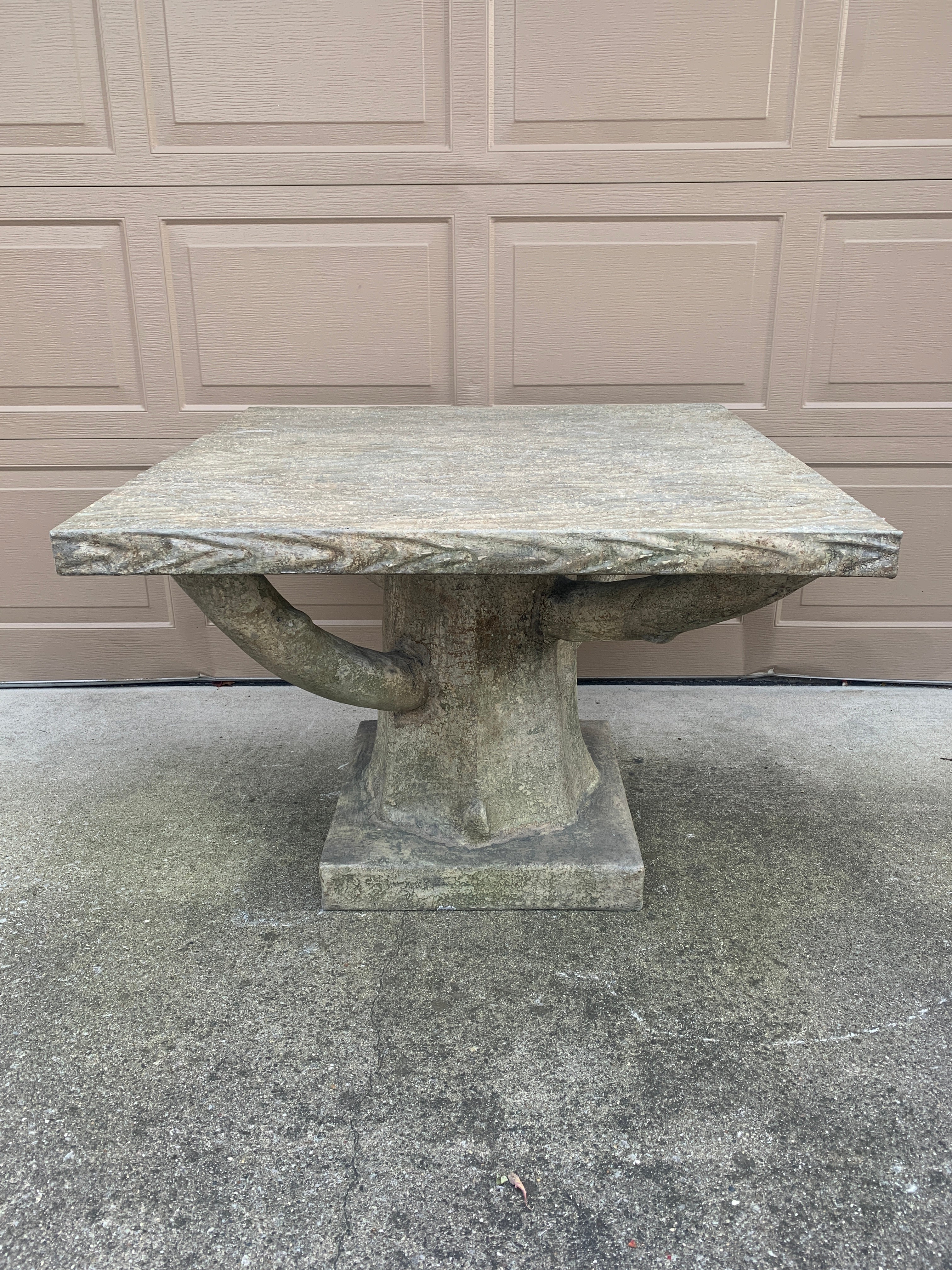 A gorgeous trompe l'oeil faux bois tree form outdoor dining table

USA, Early 21st Century

Cement over iron

Measures: 37.5
