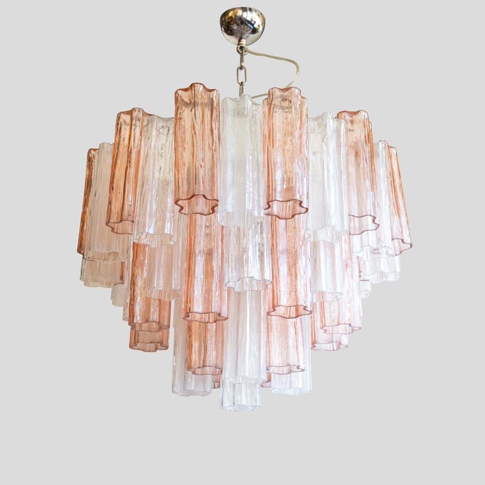 An elegant chandelier in excellent vintage condition created with high quality glass components of a pale pink and transparent color called “Trunks” for their shape. The trunks are mounted on a chromed metal structure in the shape of circles of