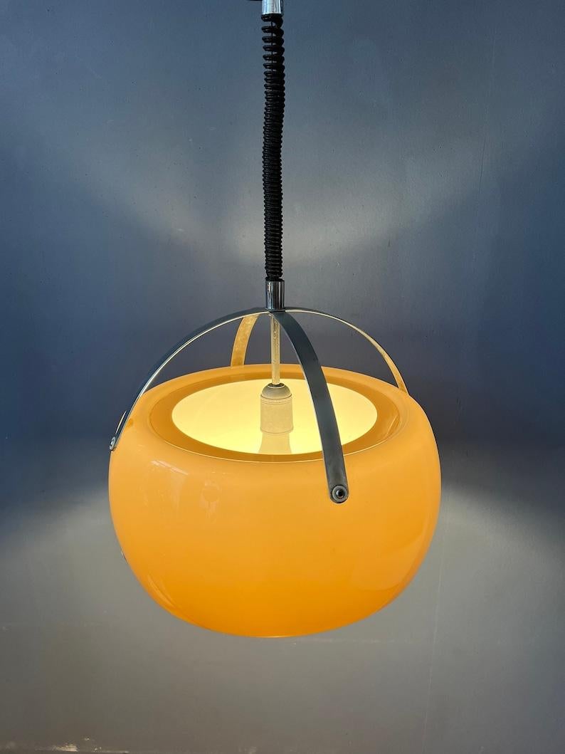 Vintage-Pendelleuchte von Emanuelle mit Acrylglasschirm und Chromgestell. Der Schirm erzeugt ein herrliches, warmes Licht. Die Höhe der Leuchte lässt sich mit dem Hebe- und Senkmechanismus leicht einstellen. Die Lampe benötigt eine E27/26