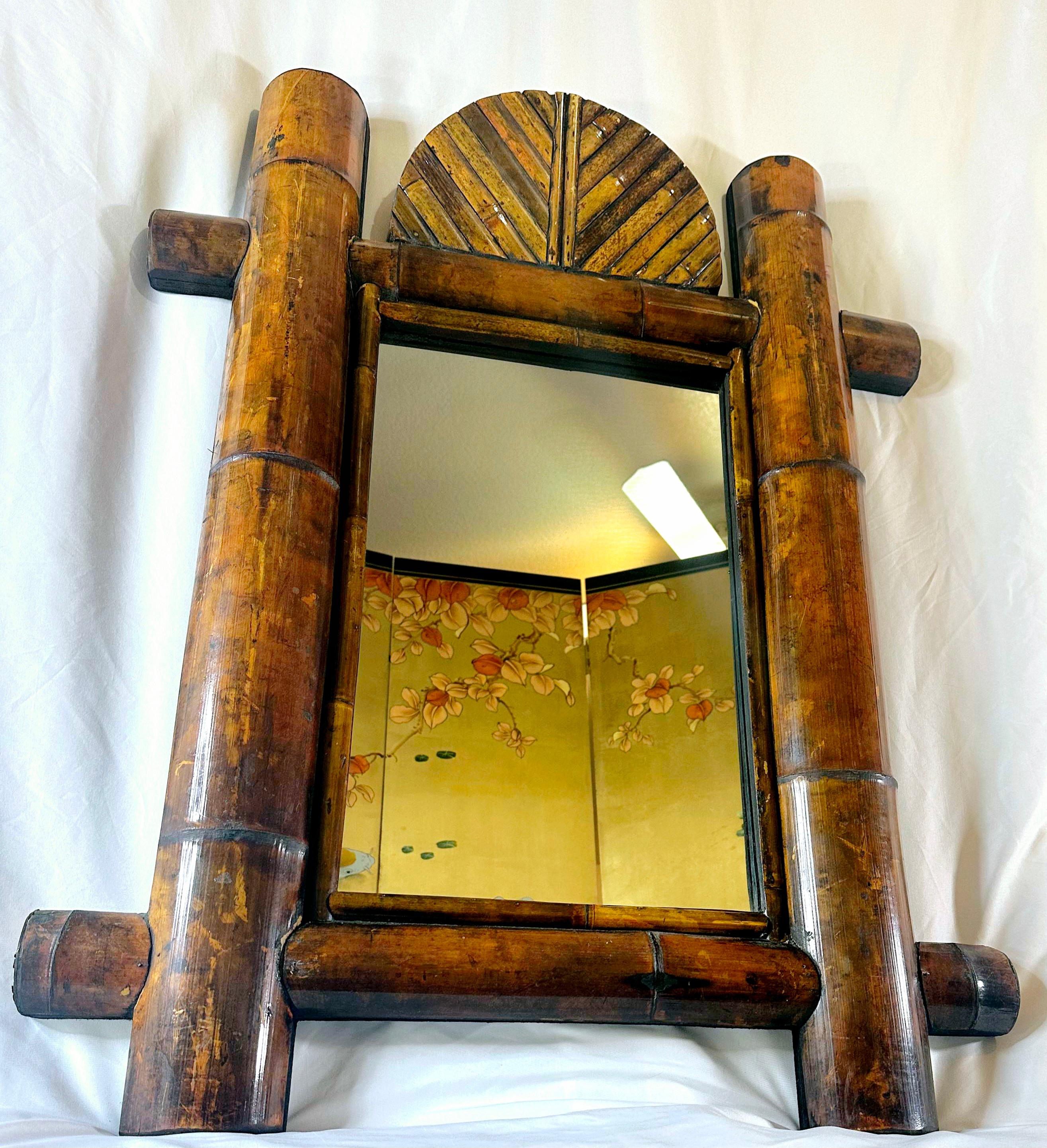 Very Tommy Bahama or Earnest Hemingway in its tropical style. 
Gorgeous color in the authentic bamboo.  
Incredible, large vintage split bamboo mirror. Four giant split bamboo pieces surround mirror with smaller bamboo pieces,  or cane rattan, as
