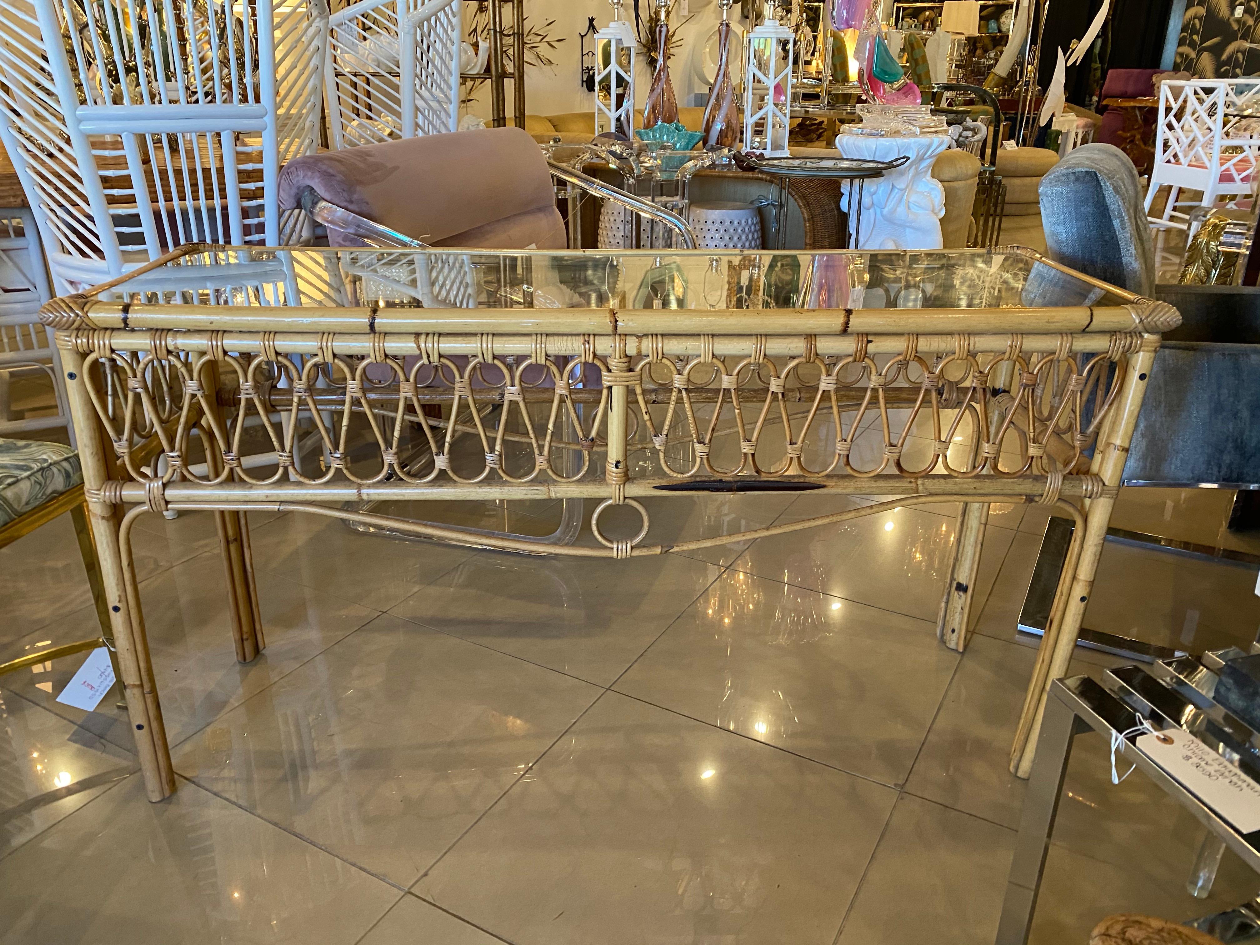 Vintage rattan console table with glass top. No missing or broken pieces of rattan.