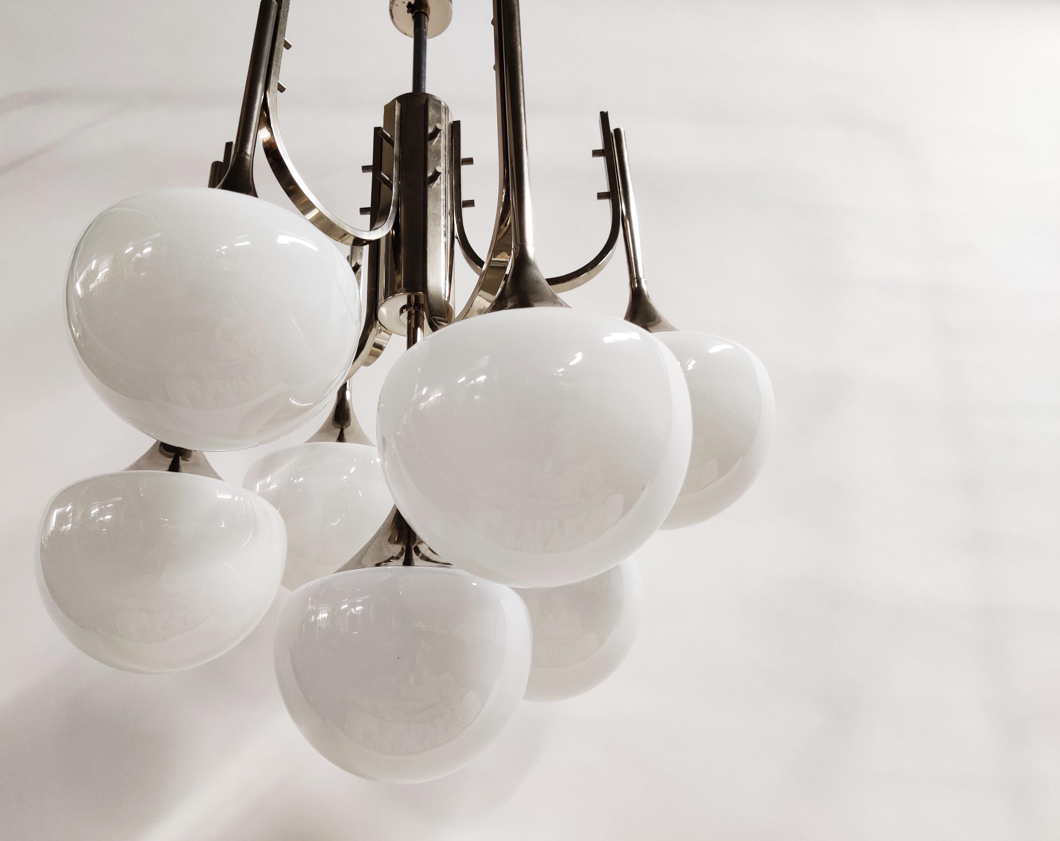 Midcentury chrome and opaline glass 'trumpet' chandelier designed by Goffredo Reggiani.

This 7-armed chandelier features half round opaline globes emitting a warm light.

The chandelier has 7 E14 light points.

The lamp has been