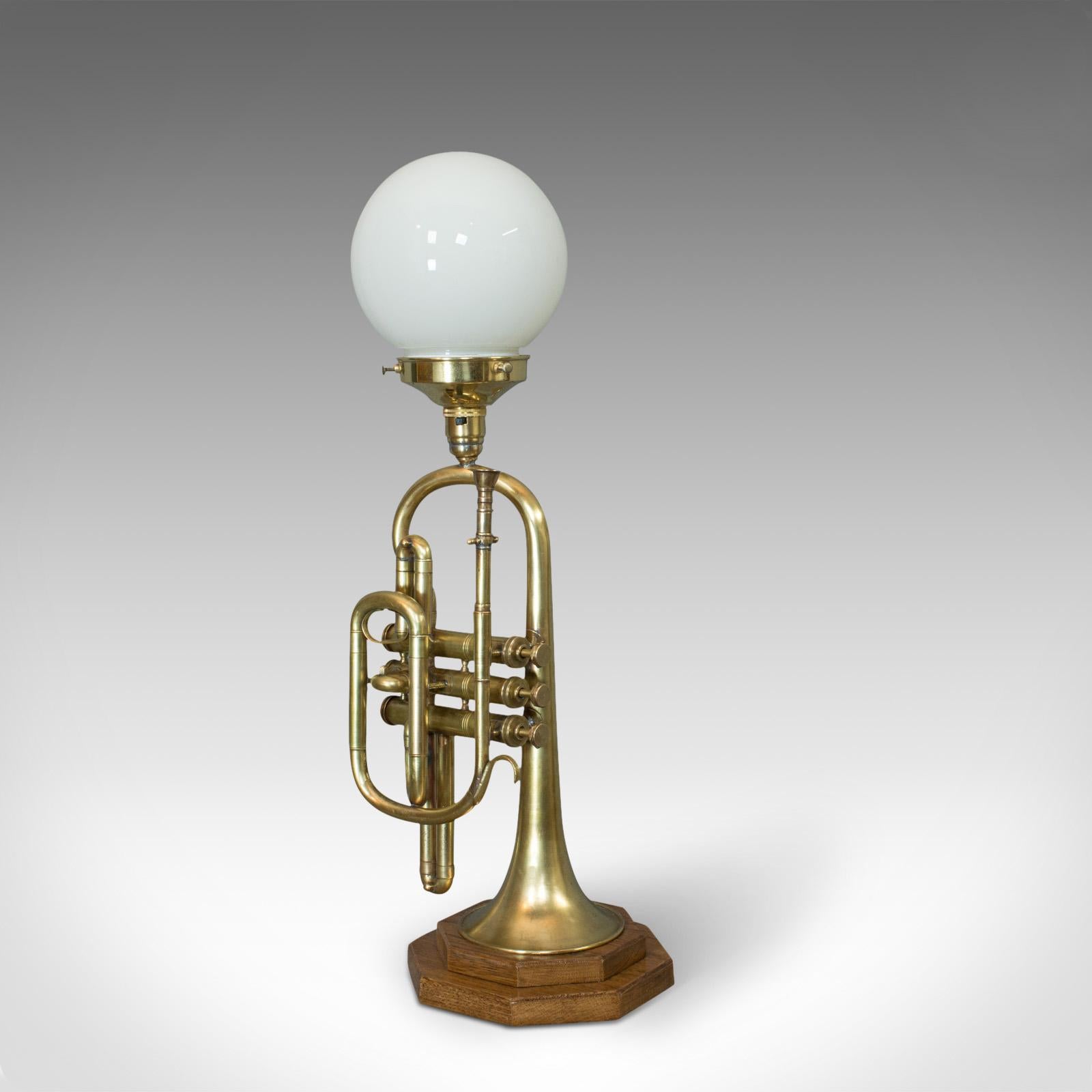 This is a vintage trumpet lamp. An English, oak and brass musical instrument light with pendant shade and dating to the 20th century.

Appealing lamp sure to hit the right note
In superb condition, fully working with quality, opaque pendant