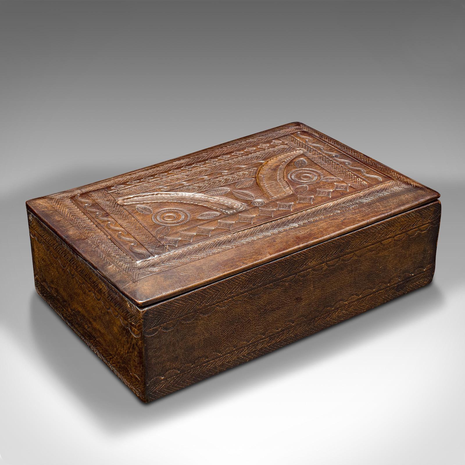 This is a vintage Tuareg hand-tooled box. An African, leather decorative case, dating to the mid 20th century, circa 1960.

Appealing leather work with a tooled decorative lid
Displays a desirable aged patina and in good original order
Leather