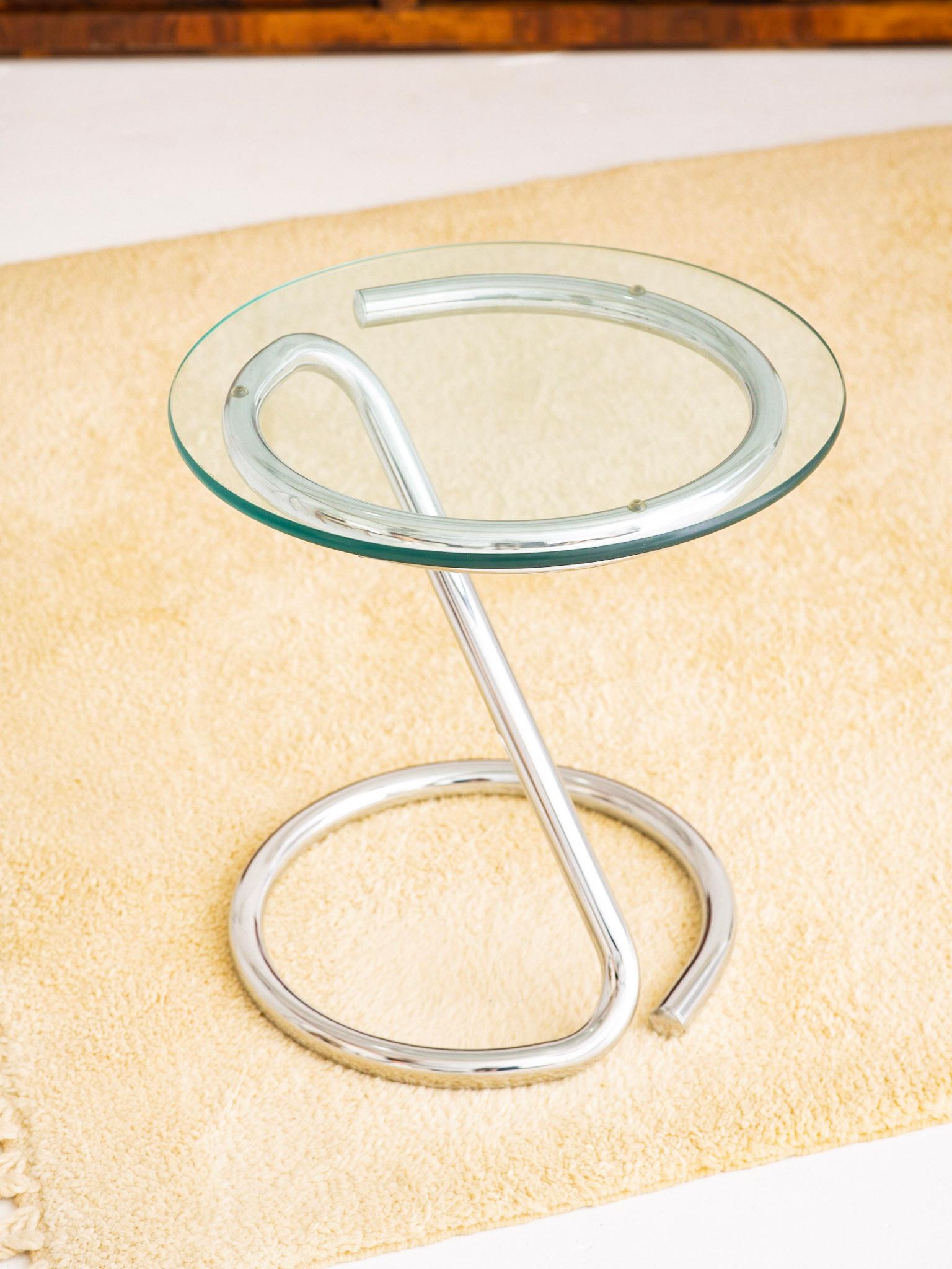 Sculptural tubular chrome accent table. “Z” shape with round glass top. In the style of Paul Tuttle.
