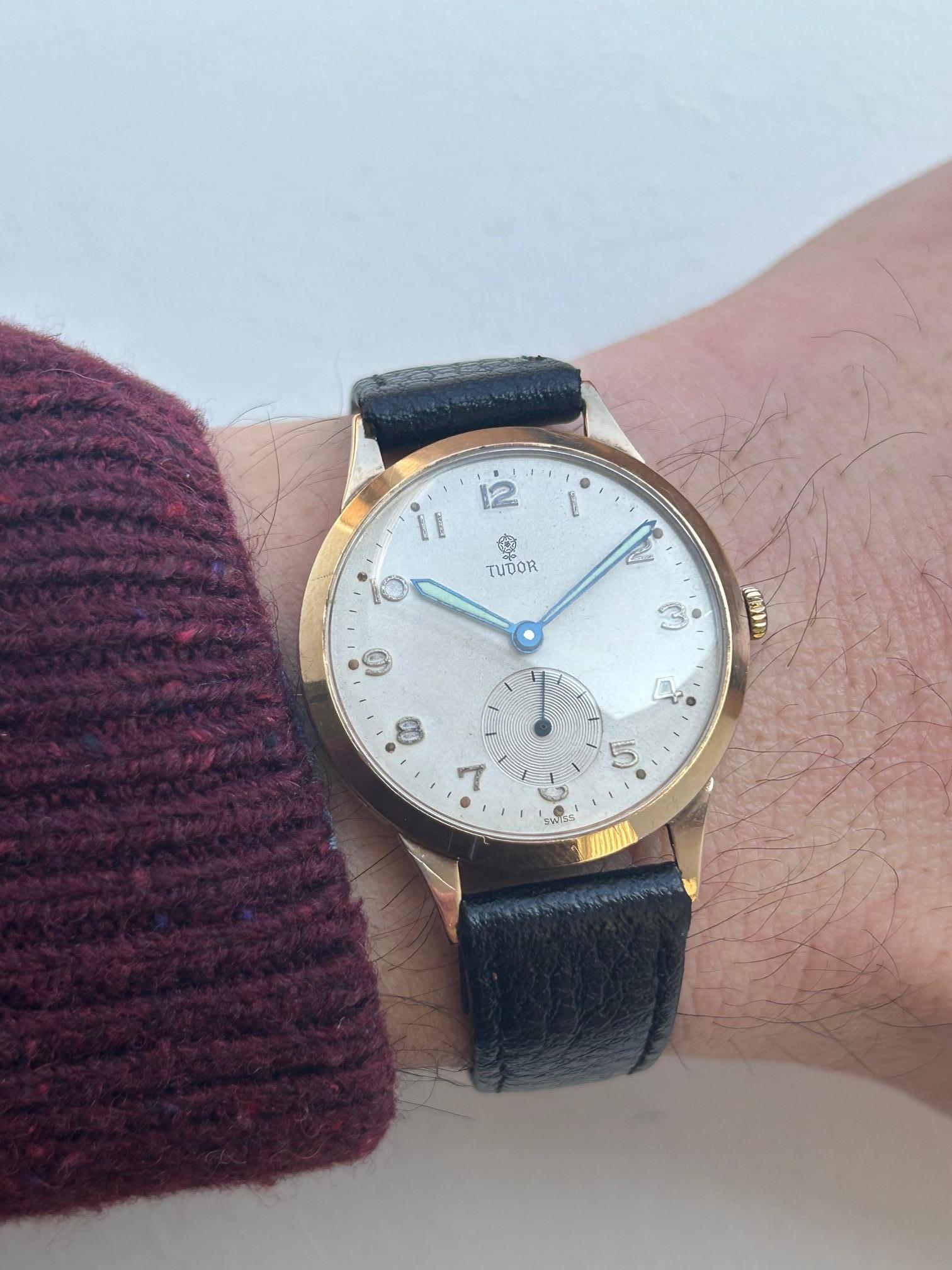 Our vintage and very attractive, manual wind, round 9k yellow gold cased Tudor, with sub seconds dial and ivory coloured arabic numeral dial, is presented in excellent condition given its age. The case measures 33mm with crown (32mm without) and