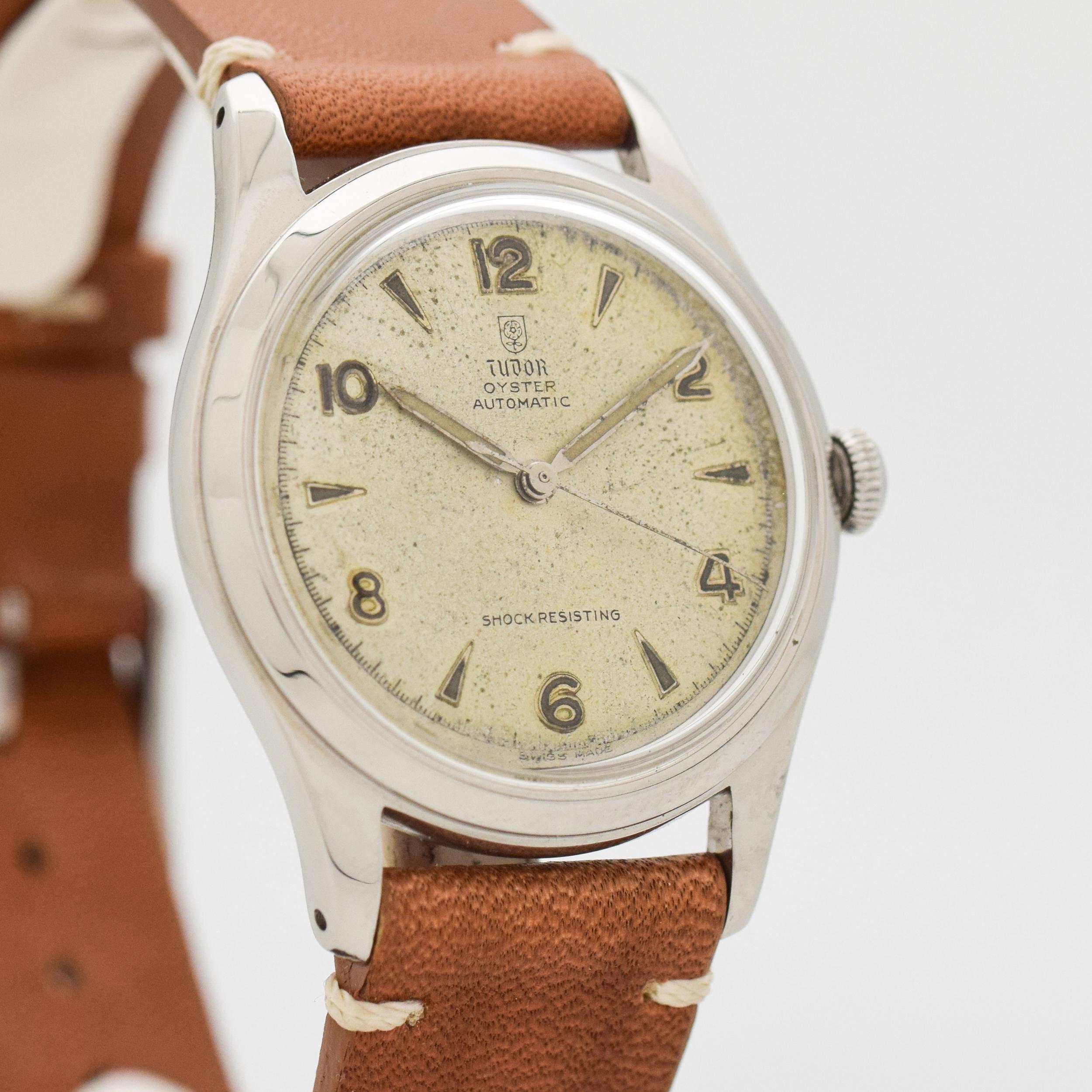 1950's Vintage Tudor Oyster Stainless Steel watch with Original Silver Dial with Applied Steel Arabic 2, 4, 6, 8, 10, and 12 with Arrow Markers. 34mm x 41mm lug to lug (1.34 in. x 1.61 in.) - Powered by a 22-jewel, automatic caliber movement. Triple