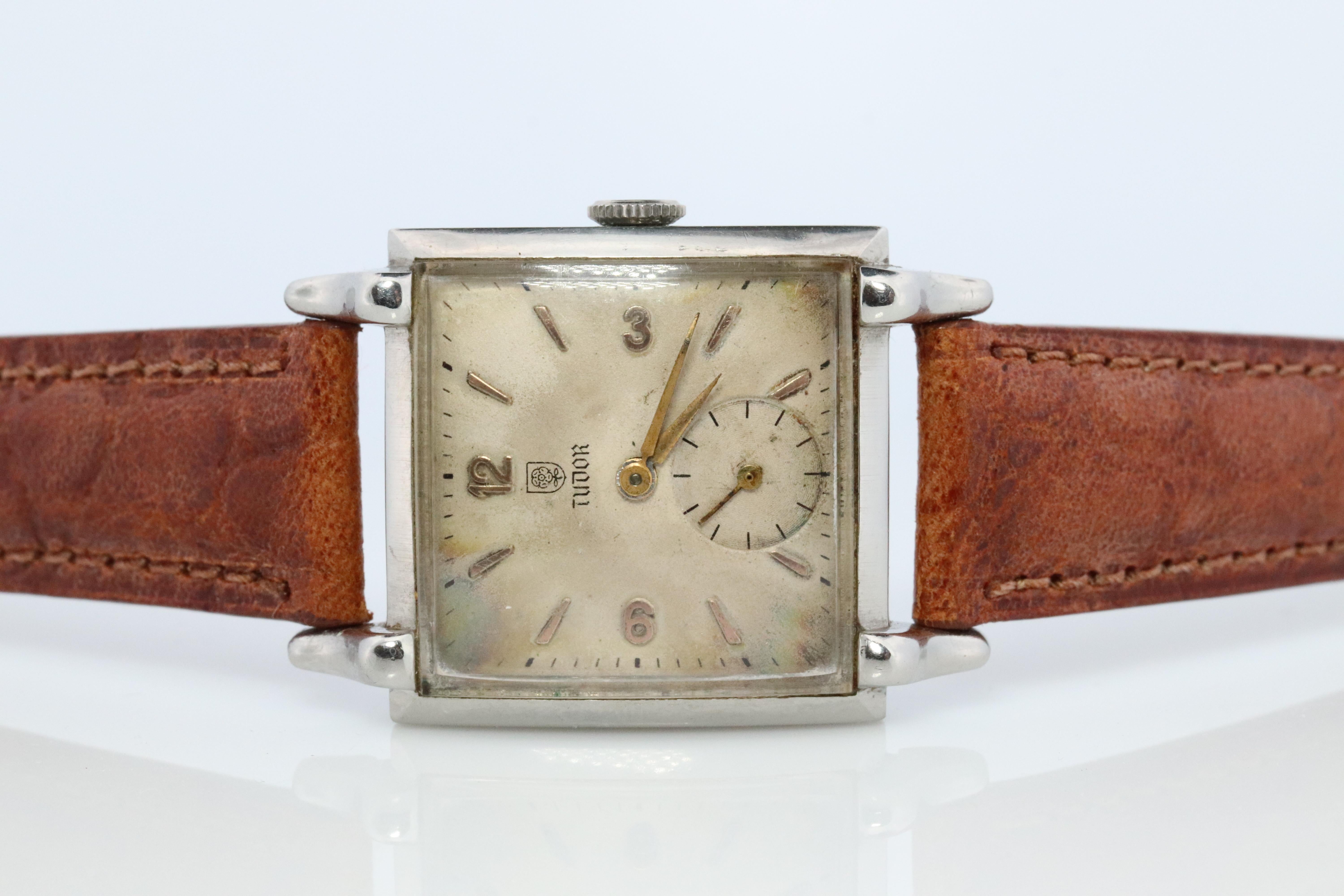 Vintage Tudor Square Mens Watch

Ref 812

Windup Movement. Runs well.

Runs and winds up well

Circa 1950s

Beautiful Watch.

Case is Stainless Steel.

New Genuine Leather band.

28mm square case