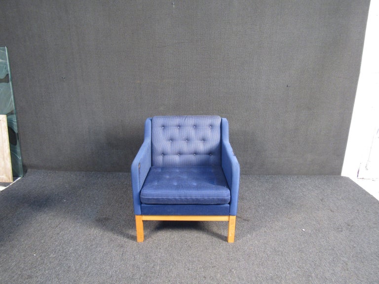 This fabulous vintage blue club chair features a tufted back rest, wooden base and is covered in a comfy blue fabric. This chair would be a great addition to any lounge space.

Please confirm item location (NJ or NY).