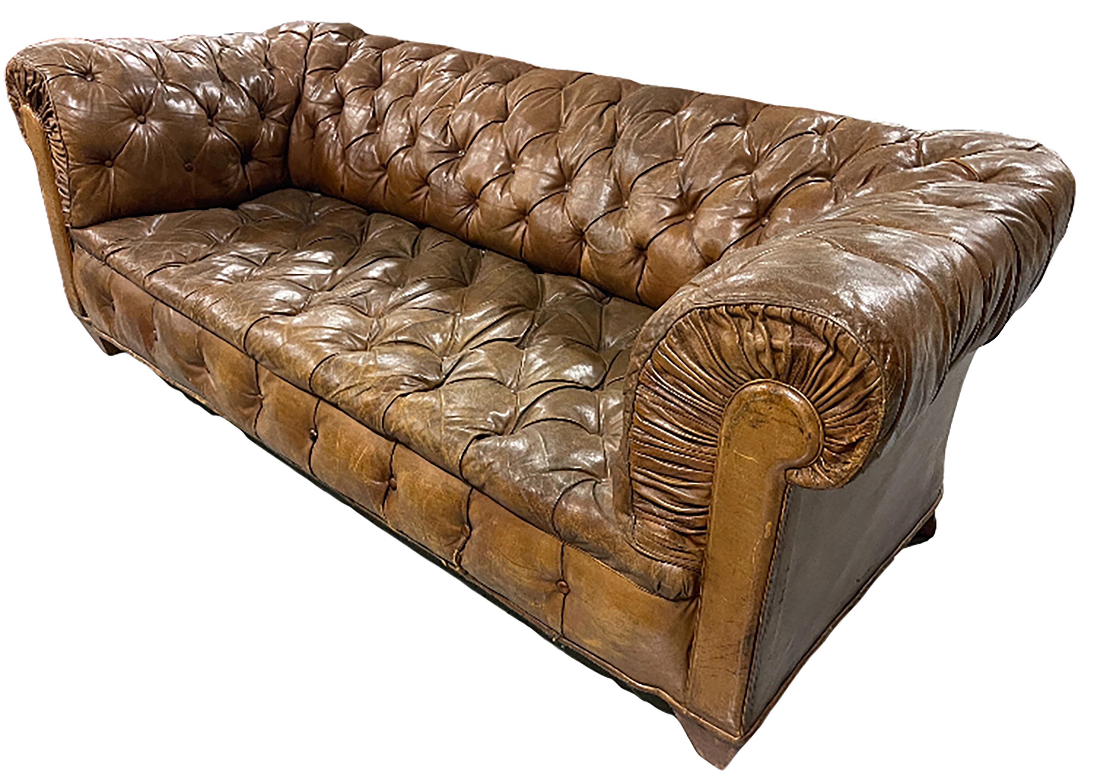 A handsome vintage tufted Chesterfield sofa. Upholstered in a whiskey brown antique French leather. Tufted rolled arms and backrest with solid cushion seat.

In very good condition.

No obvious markings present on the piece. 

This comfortable sofa