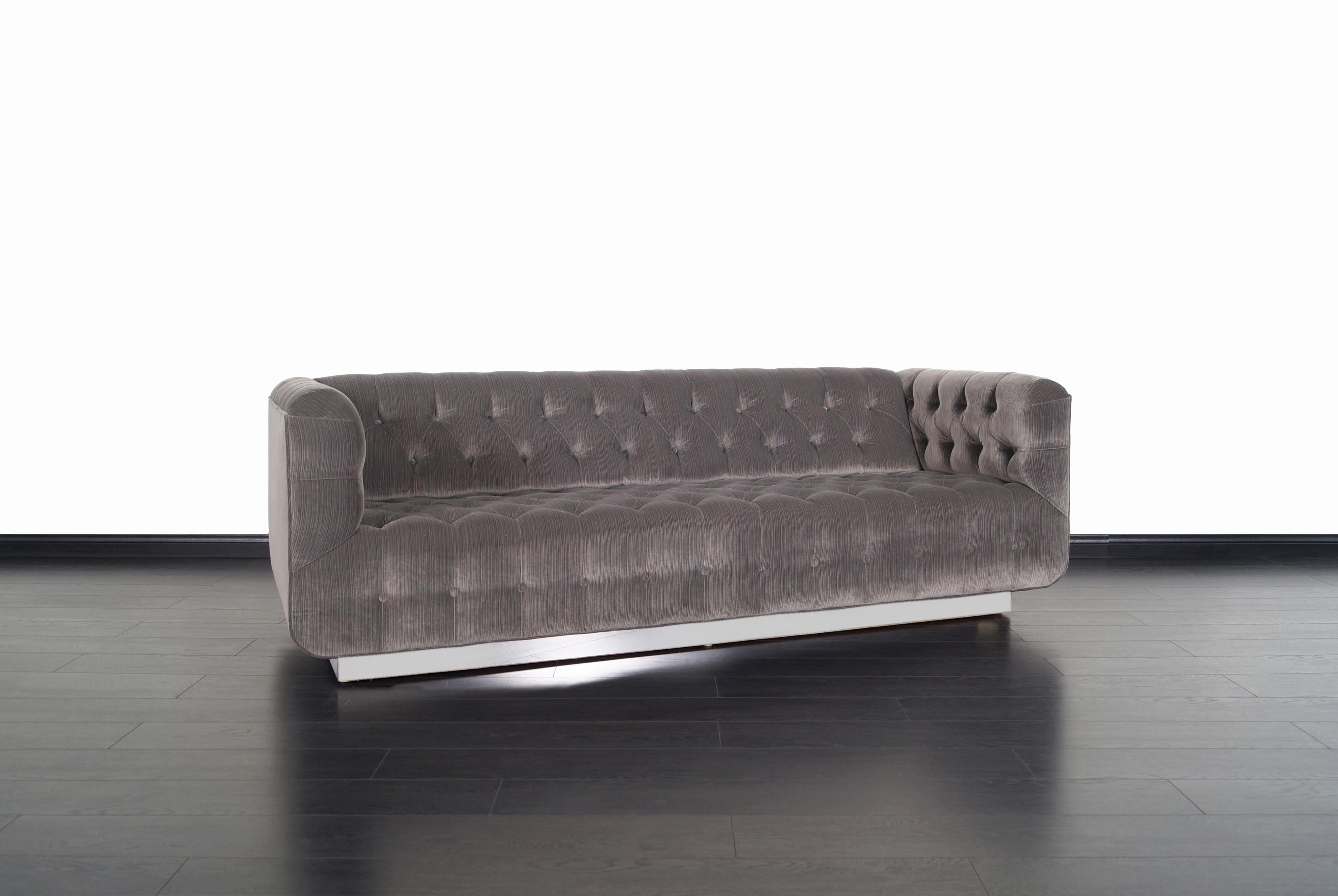 Spectacular vintage chrome sofa by California designer George Kasparian for Kasparian Inc. Professionally reupholstered in a diamond tufted design with a fine velvet. Its modern and elegance make it the perfect complement to your home or office.