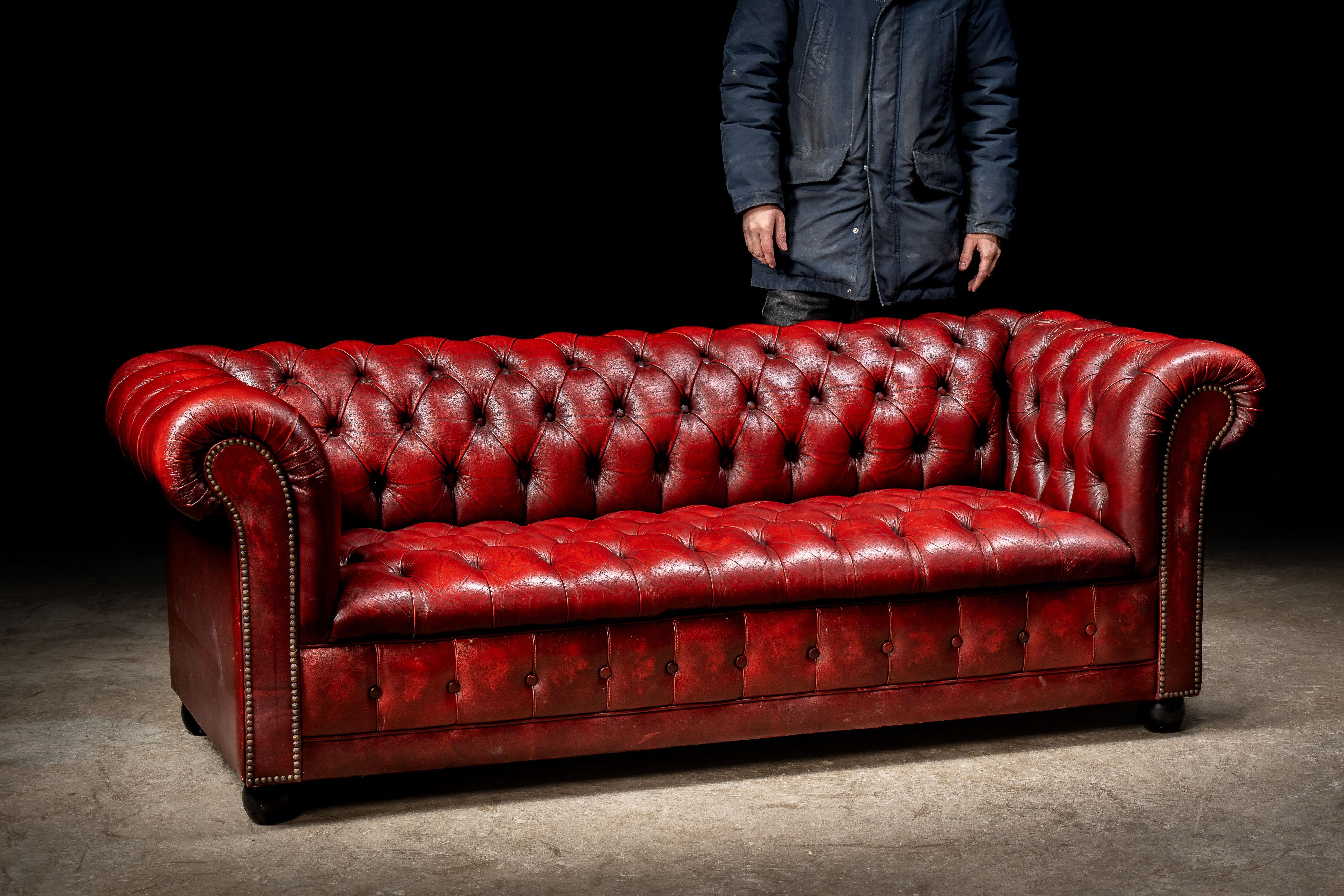 Vintage tufted leather Chesterfield sofa.

An eye-catching leather Chesterfield featuring deep button tufts and plush interior padding, all wrapped up in a candy apple-red shell. Lightweight, durable, and perfect for smaller seating areas. 

75