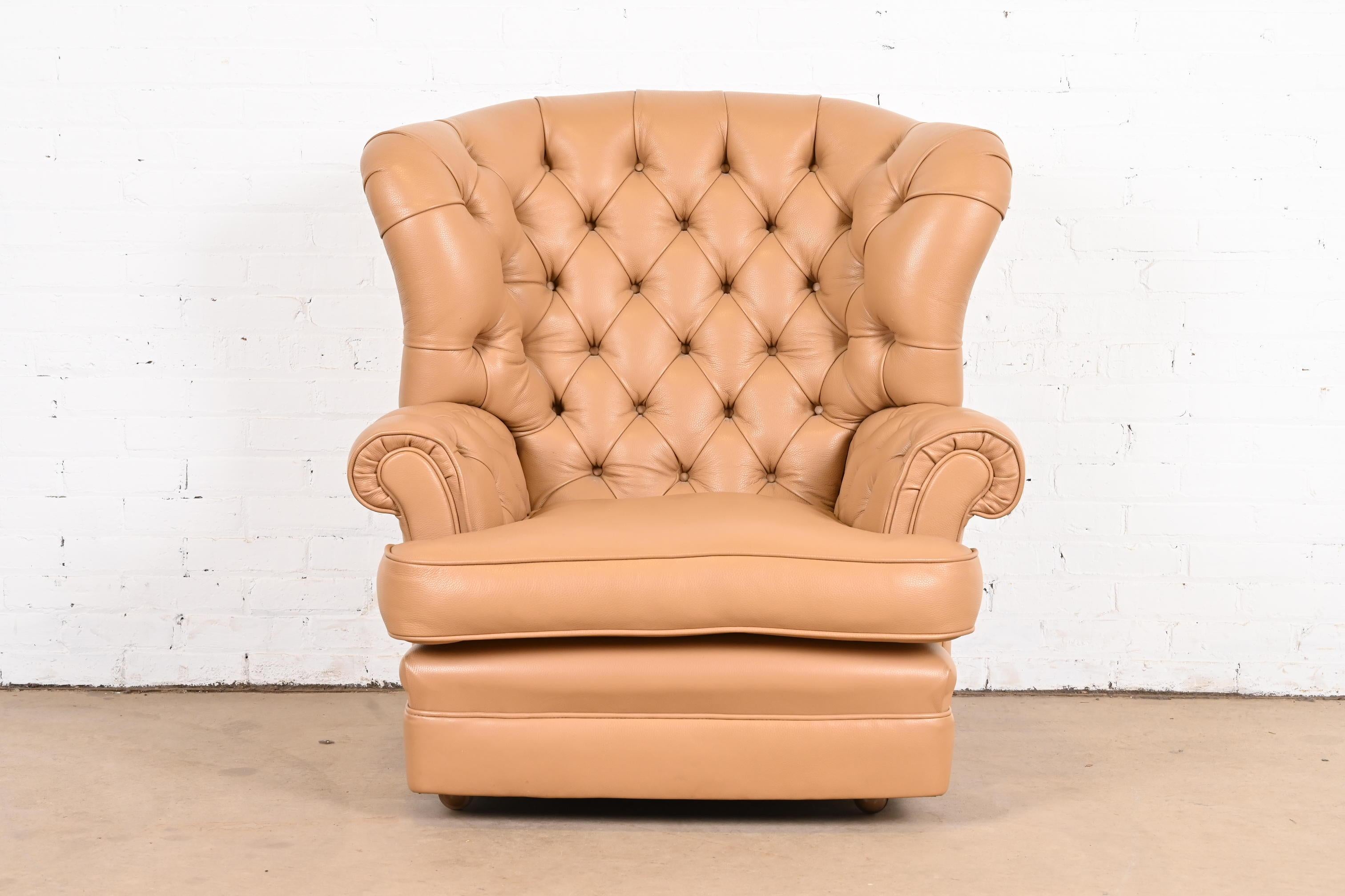 A gorgeous Chesterfield style wingback fireside chair, club chair, or lounge chair

USA, Late 20th Century

Tufted leather, on rolling castors.

Measures: 38