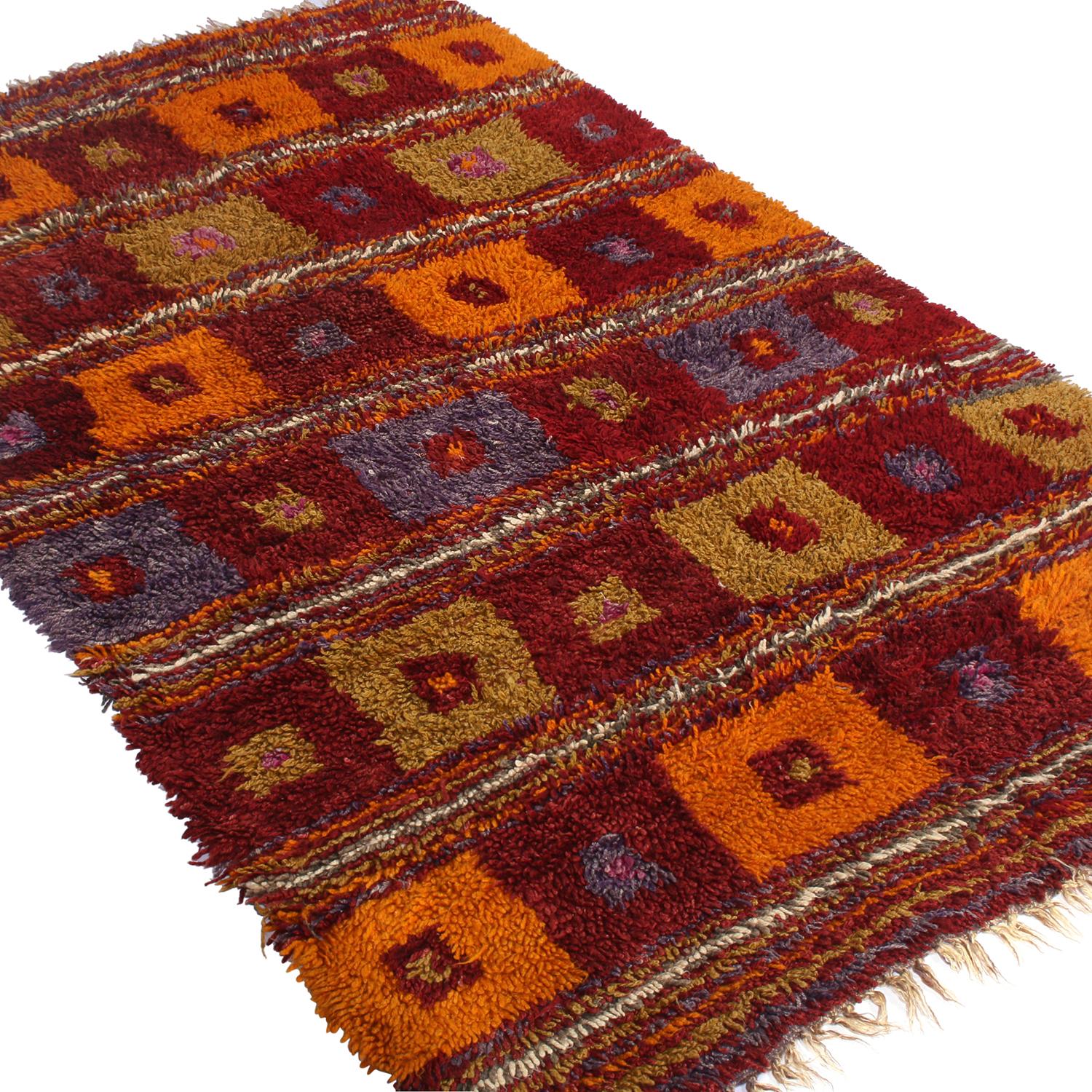 Hand knotted with lush, high pile shag wool originating from Turkey between 1950-1960, this vintage Tulu rug enjoys a fabulous and unique marriage of tribal sensibility with an intriguing range of classic traditional hues. Both the warmth of the
