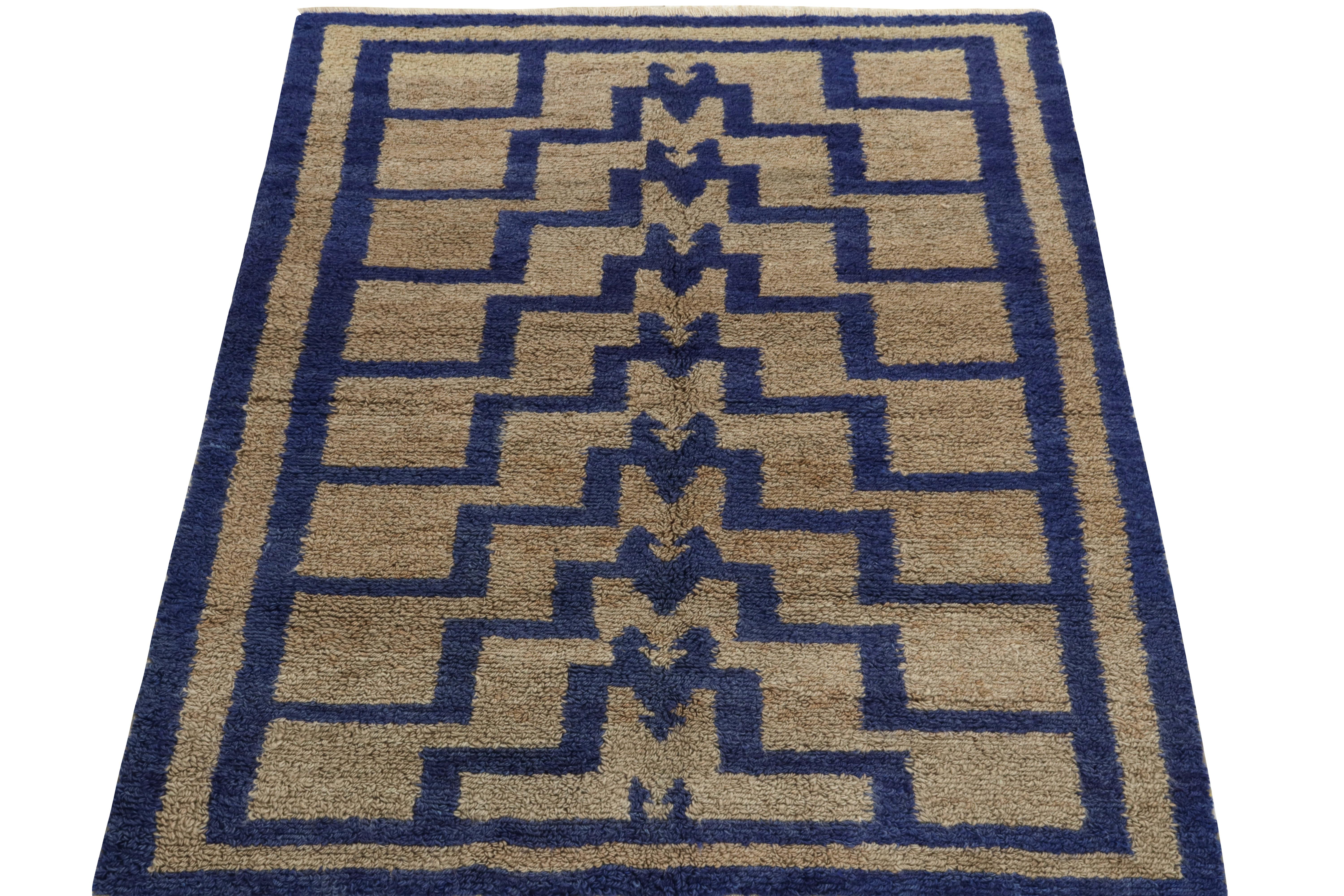 Hand-knotted in wool from Turkey circa 1950-1960, a vintage 4x6 Tulu rug from our antique & vintage collection featuring a symmetric geometric pattern. The complementary blue and beige-brown colorplay brings out textural richness to the luscious