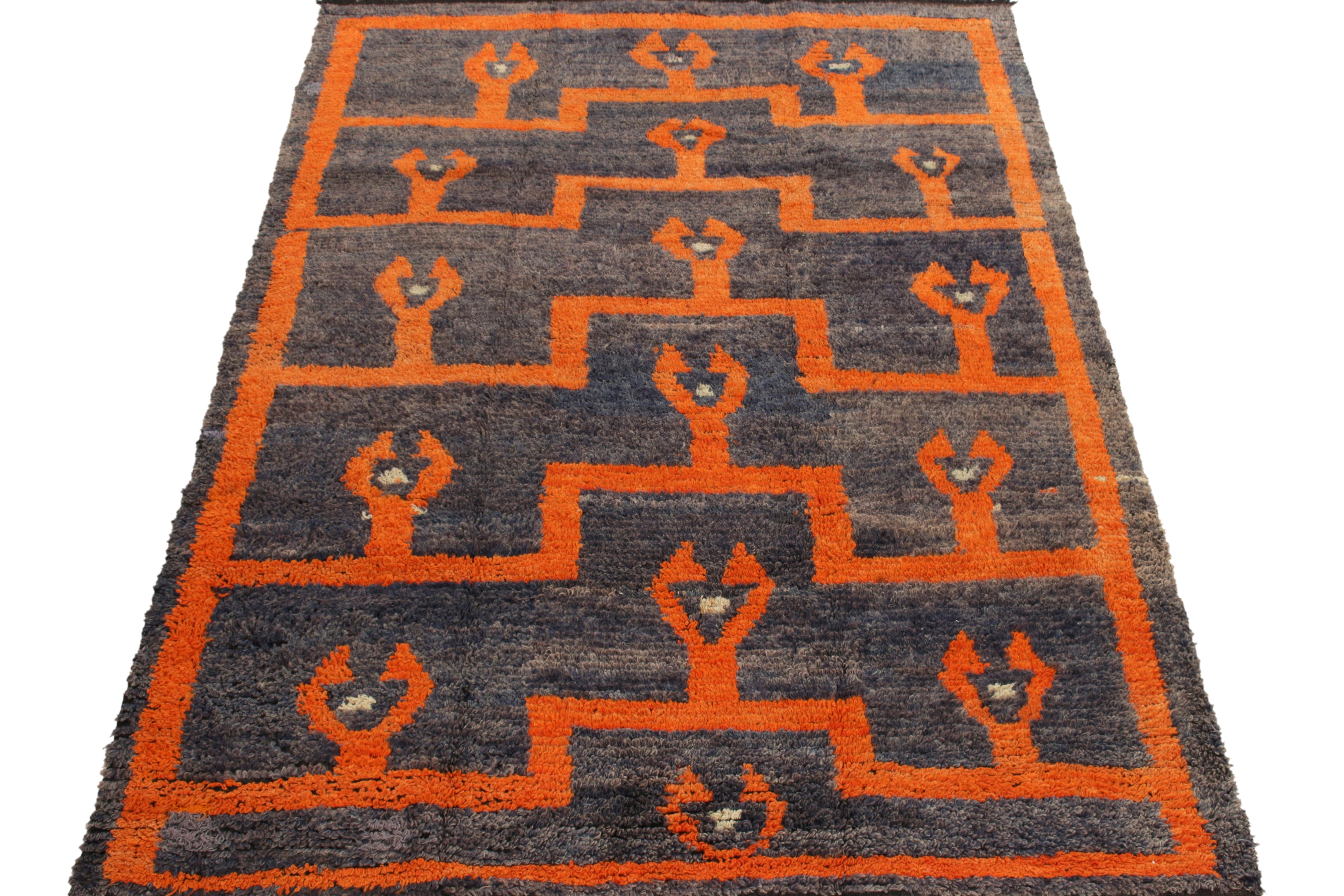 Hand-knotted in wool from Turkey circa 1950-1960, a vintage 5x7 Tulu rug from our Antique & Vintage collection celebrating the mid century approach to this style. Enjoying a symmetric geometric pattern in gray-blue, white and bright orange for a